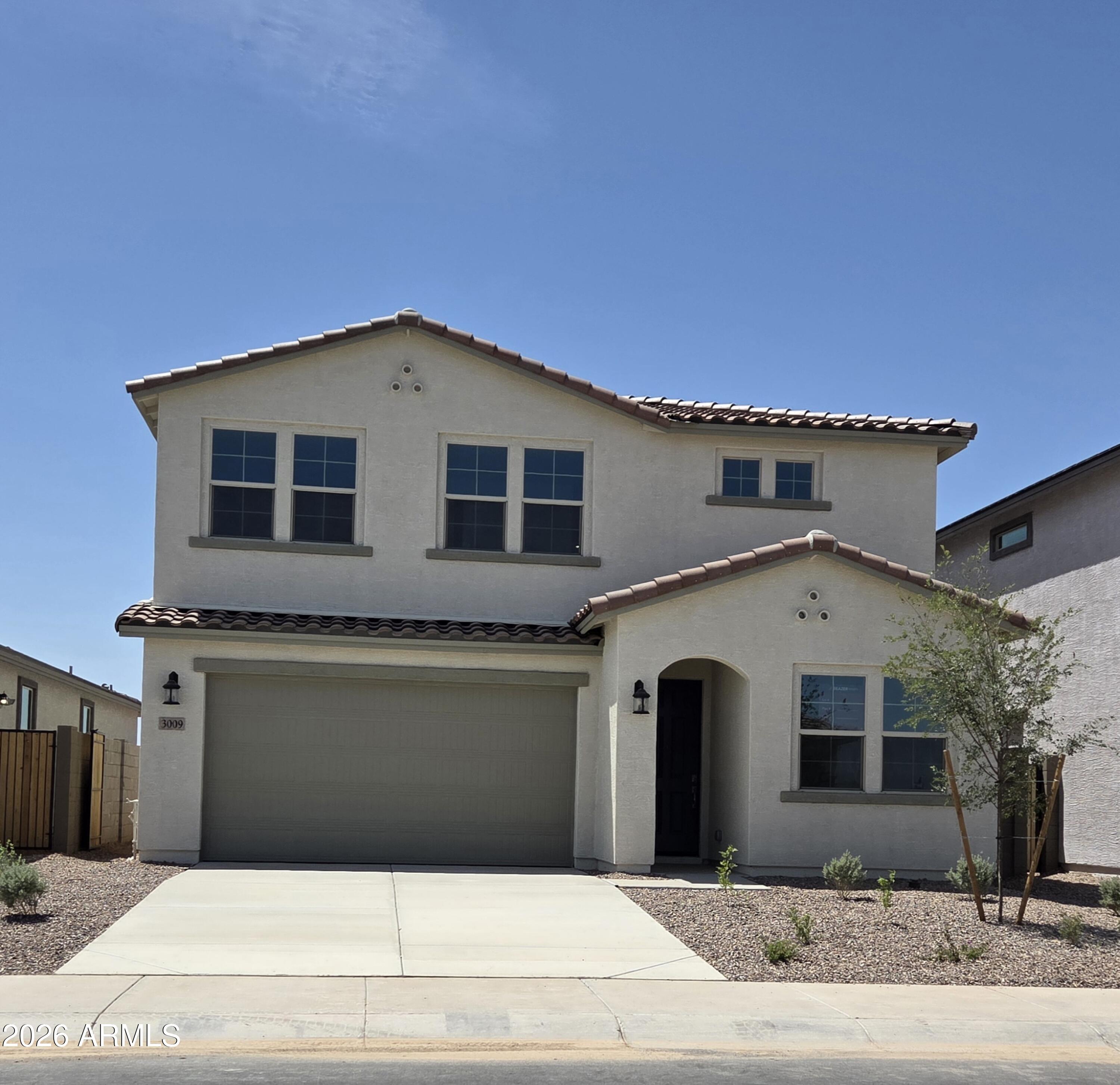 This home features a spacious 5-bedroom, 4-bath full bathrooms , with a bedroom and full bathroom located downstairs. Upstairs, you'll find 4 bedrooms, a loft, and a full walk-in laundry room. The open floor plan includes a formal dining room and a large, covered patio, plus there are no houses directly behind, which offers extra privacy. Additional highlights include laminate flooring throughout minus carpeted bedrooms, 9' ceilings with 8' interior doors, stainless appliances including a refrigerator, white washer and dryer, tile backsplash in the kitchen, and OWNED SOLAR.  Located in the desirable San Tan Valley.