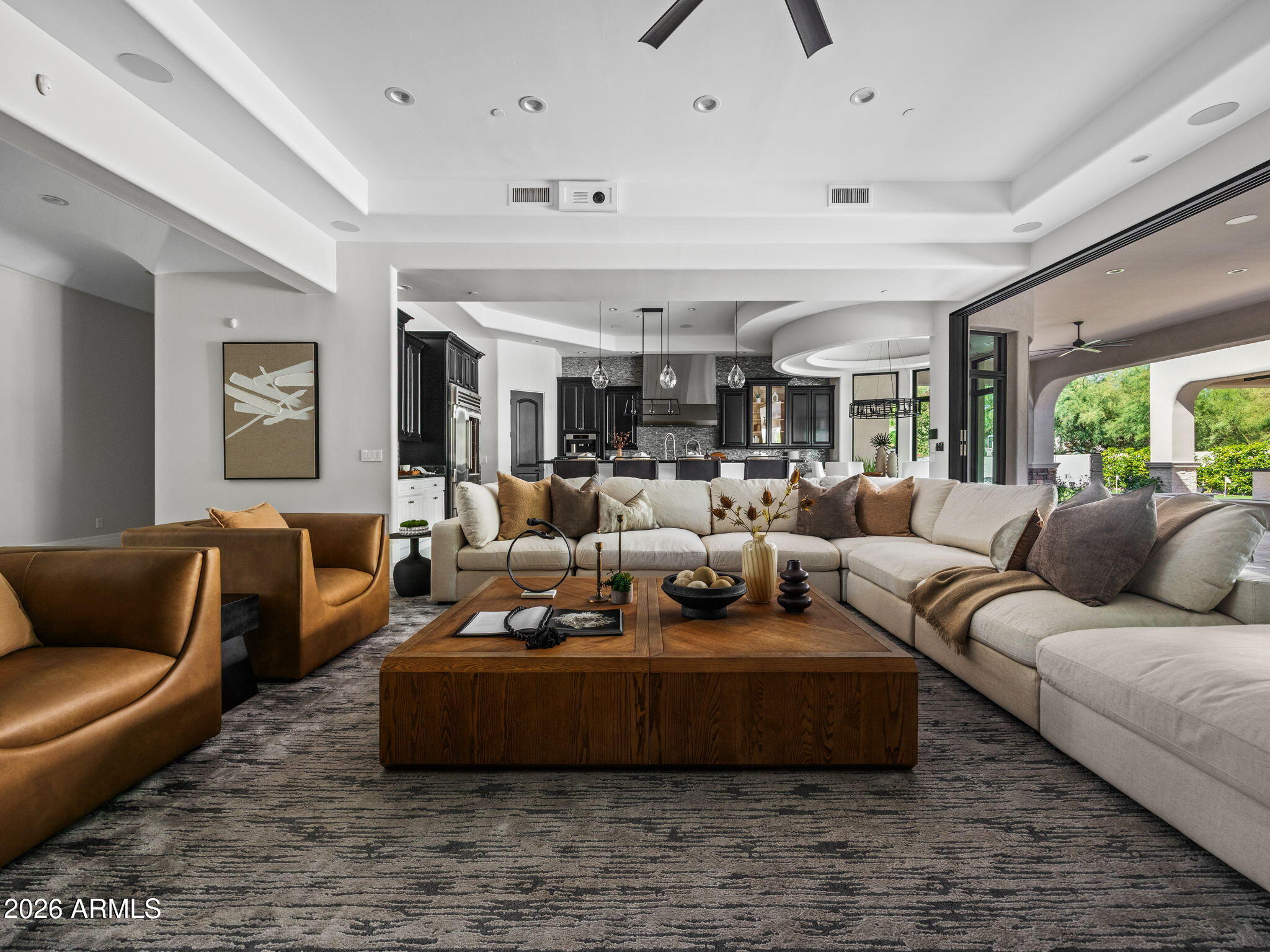 Experience the pinnacle of sophisticated living in this fully reimagined contemporary smart home in the heart of the Cactus Corridor. Fully integrated with Control4 automation, the residence features an open-concept chef's kitchen with a built-in espresso station, dual dishwashers & premium appliances. The expansive great room transforms into a private cinema with a concealed projection screen, while floor to ceiling sliders lead to the ultimate outdoor retreat.
The resort-style backyard is an entertainer's dream, boasting a heated & chilled pool with a swim-up bar, zero-edge spillover spa & five outdoor TVs. An elevated culinary pavilion features a teppanyaki grill, dual grilling stations & a fire bar social hub. For active living, enjoy a private pickleball/sport court, putting green & lush turf zones surrounded by over height privacy walls. Automotive enthusiasts will appreciate the extended length 3 car garage, featuring soaring ceilings with the ideal clearance to add vehicle lifts.
The primary suite serves as a true wellness sanctuary, complete with a private sitting room, infrared sauna, steam shower and soaking tub. All secondary bedrooms are ensuite with walk-in closets.