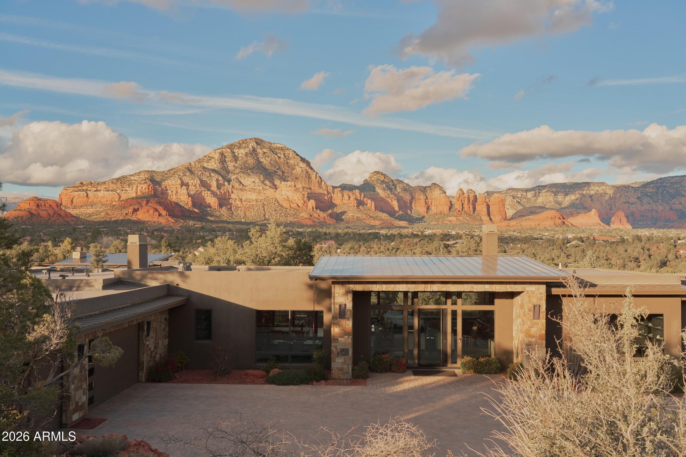 RARE OPPORTUNITY: THE ULTIMATE SANCTUARY. Experience complete peace, privacy, and solitude in this West Sedona luxury masterpiece. Custom built in 2022, this 4,550 sq ft residence sits on over two acres with no HOA and directly borders national forest, offering a rare level of seclusion just minutes from town. Over $800,000 in curated upgrades elevate every space, from the chef's kitchen featuring Wolf and Sub-Zero appliances to full home automation and expansive decks designed to capture Sedona's iconic red rock vistas. Strategically priced at approximately $1,000 per square foot, this offering represents exceptional value for a nearly new luxury home of this caliber. Take advantage of this rare opportunity to secure a 2022 build in one of Sedona's most private settings.