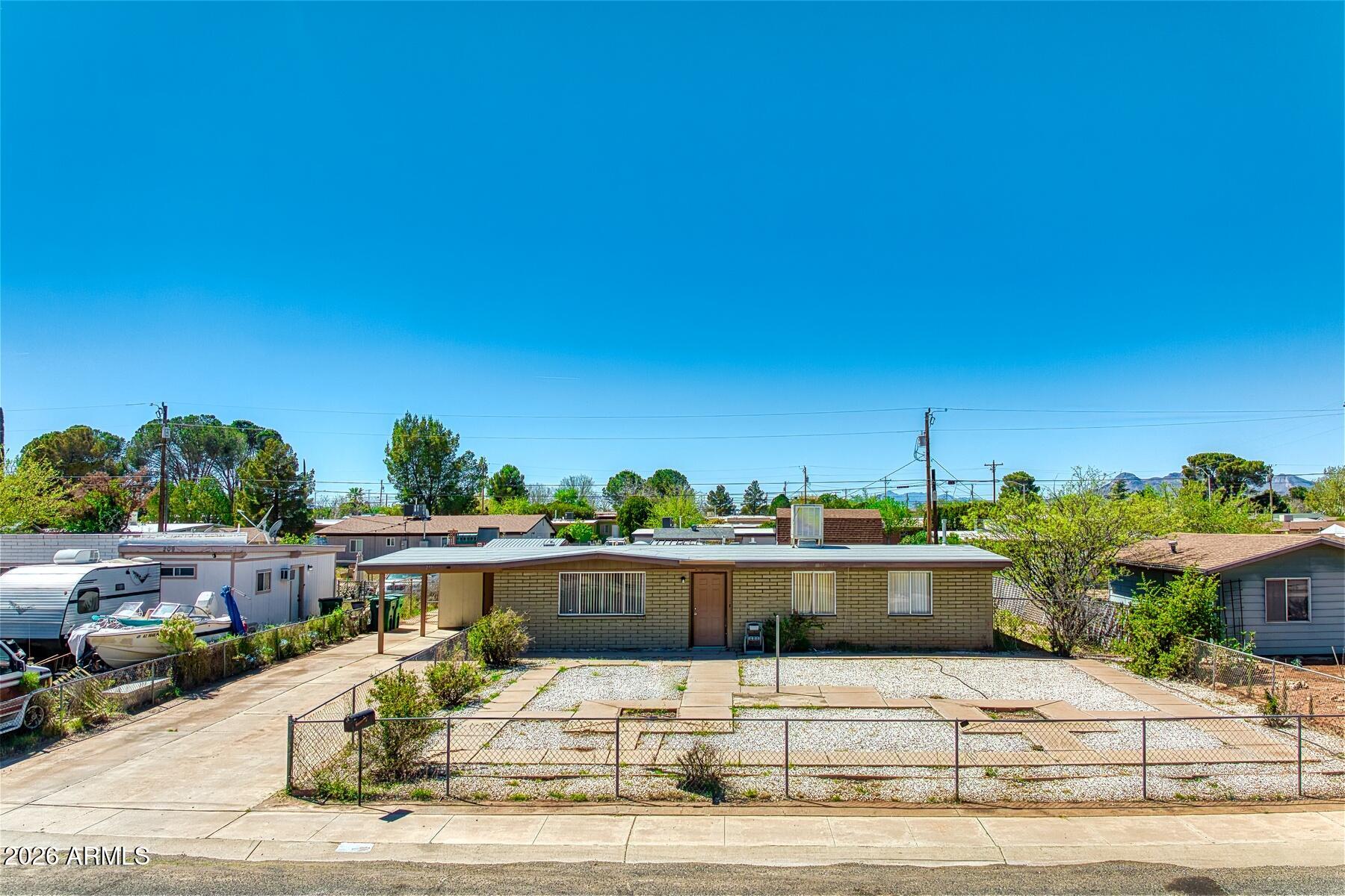 This cute home located in upper Huachuca City features a fenced yard with 3 bedrooms, 2 baths along with a kitchen and dining area and a large living area.  The home has had all new carpet installed and is ready for new owners.  You'll also find the enclosed back patio is a great place to sit and enjoy or use as a work space.  In the back yard you have 2 storage buildings that would make a great workshop and storage for all those holiday items.  There's also a carport with storage as well as laundry.  This home also has had the walls drywalled so it stays warmer in the winter and the roof was redone 2 yrs ago.