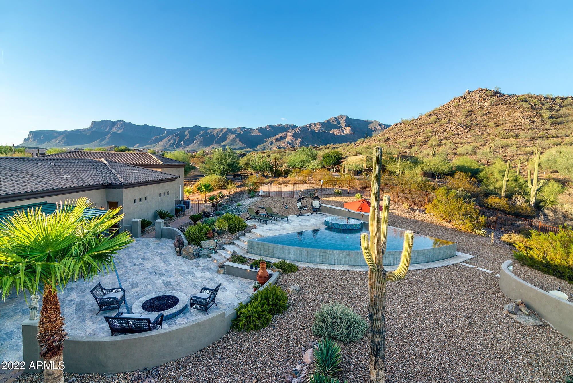 Must see VIEWS, BACKYARD OASIS with an RV GARAGE that is AIR CONDITIONED and HEATED on 1.27 Acres!  This custom home has a great open floor plan with a huge kitchen, tons of counter space, double ovens, walk in pantry, large dining rooms, very high ceilings, four bedrooms with their OWN bathrooms, den, secret room, extra deep garage spaces with built in cabinets for tons of storage!  From both the large front wrap around patio and walk deck above you will enjoy beautiful sunsets and Dinosaur Mountain views!  The huge fenced in backyard features a covered outdoor kitchen BBQ area with seating overlooking the amazing pool and spa with an infinity edge that water falls down the whole side and corners of the pool.  Come enjoy these backyard Superstition and other nearby mountain views!!