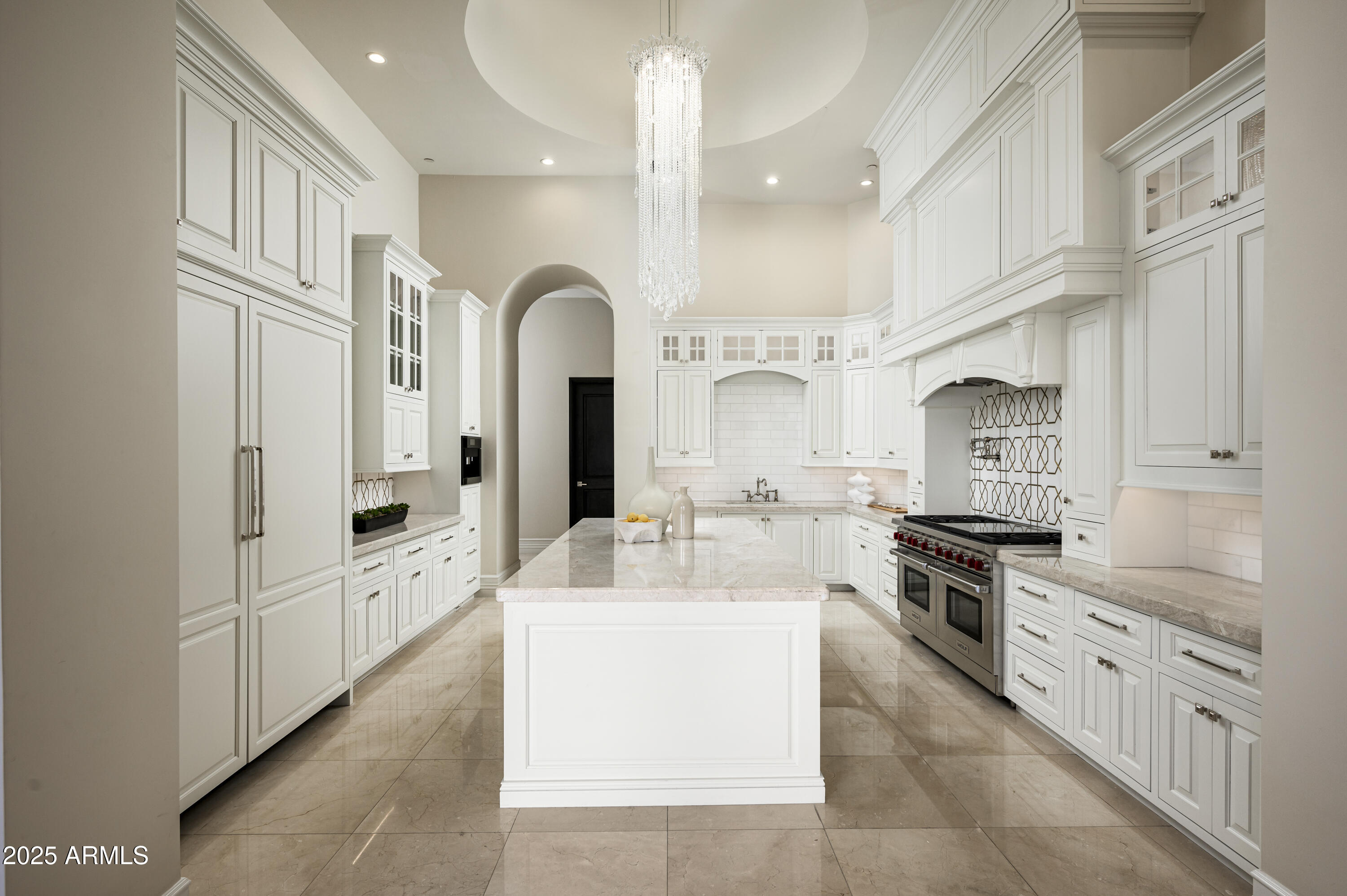 This exquisite single-level property offers a blend of luxury + sophistication. Featuring 6 bedrms + 8 bathrms spread across its expansive 9,372 sqft, it showcases breathtaking views of Mummy Mountain, McDowell Mountain, + city lights. The guest casita, complete with a living rm, kitchen, bedrm, + bathrm provides a private retreat for visitors. The main house features 5 ensuite bedrms, a gym, media rm, library, + flex rm ensuring a perfect balance of comfort + entertainment. The spacious chef's kitchen with large white quartzite island also features an additional full catering  kitchen. Floor-to-ceiling windows + sliding pocket doors seamlessly merge indoor + outdoor living, while the zero-edge pool, spa, artificial turf + magnificent views offer a resort retreat