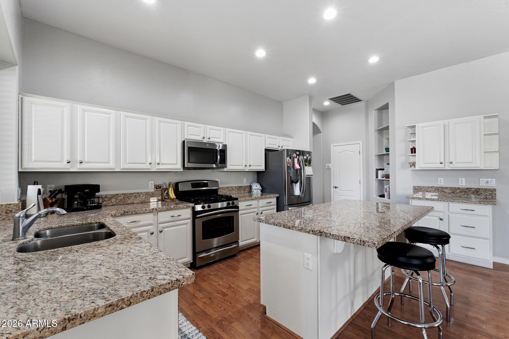 Beautiful Single-Level Gilbert Home 
This inviting single-level, 4-bedroom home sits in the highly sought-after, mature community of The Estates at North Shore-a prime Gilbert location. With both formal living/dining areas and a spacious great room, there's plenty of room to relax, gather, and entertain.
The bright eat-in island kitchen features crisp white cabinetry, neutral countertops, a pantry, and stainless-steel appliances. The great room's stone fireplace adds warmth and charm to the heart of the home.
The expansive primary suite includes dual sinks, a soaking tub, separate shower, and sliding doors that open directly to the lush backyard. Step outside to enjoy the covered patio, TURF play area, and a sparkling pool--perfect for unwinding or hosting family & friends.