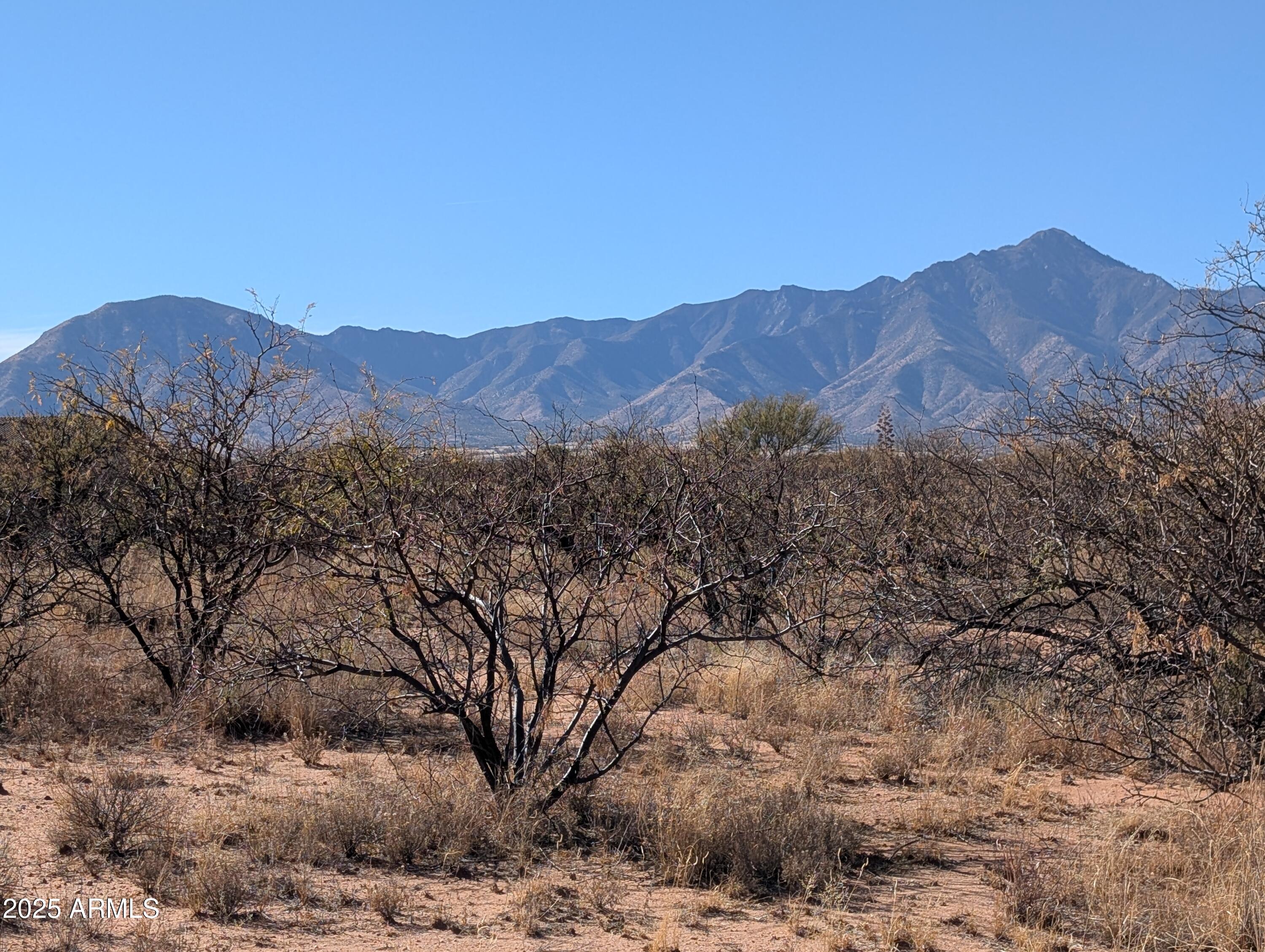 Welcome home to your 20 acres of Arizona sunsets and mountain views in a gated community with site-built homes only. Power at the lot line and backing to a wash on the northwest corner. Flat portion for easy building. Own your piece of the old west with incredible views, high-speed internet, power, and tranquil star-filled nights. Seller willing to divide into two smaller parcels.