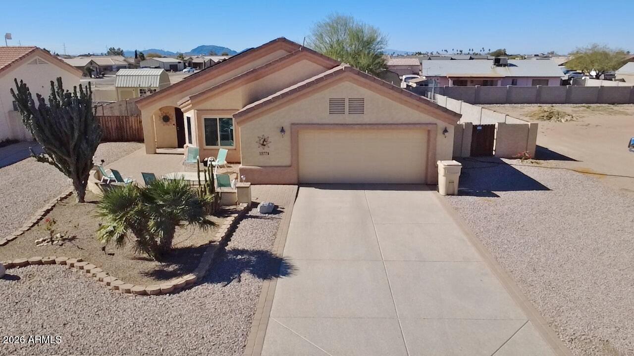 DO YOU & YOUR RV NEED A HOME? It doesn't get any better than this. Situated on 2 lots, one behind the other, completely fenced, landscaped & more. Extended paver Courtyard greets you when you drive up to this beautiful gently lived in 4 BR winter home that has been well taken care of inside and out. Enjoy the Open floorplan/Great room, island kitchen, pantry, breakfast bar & all appliances convey, OWNED SOLAR, 2X6 construction, tile roof, tile flooring except BR's, ceiling fans, new windows 2021, epoxy garage/driveway & insulated garage door. Outside there are extensive paver patios in back plus a Pergola, Large Shop/Shed, meticulous landscaping front & back, block fencing, RV Hook ups, RV gate, & all graveled. Lots of tools, patio furniture & more will convey with the property. NO HOA!!