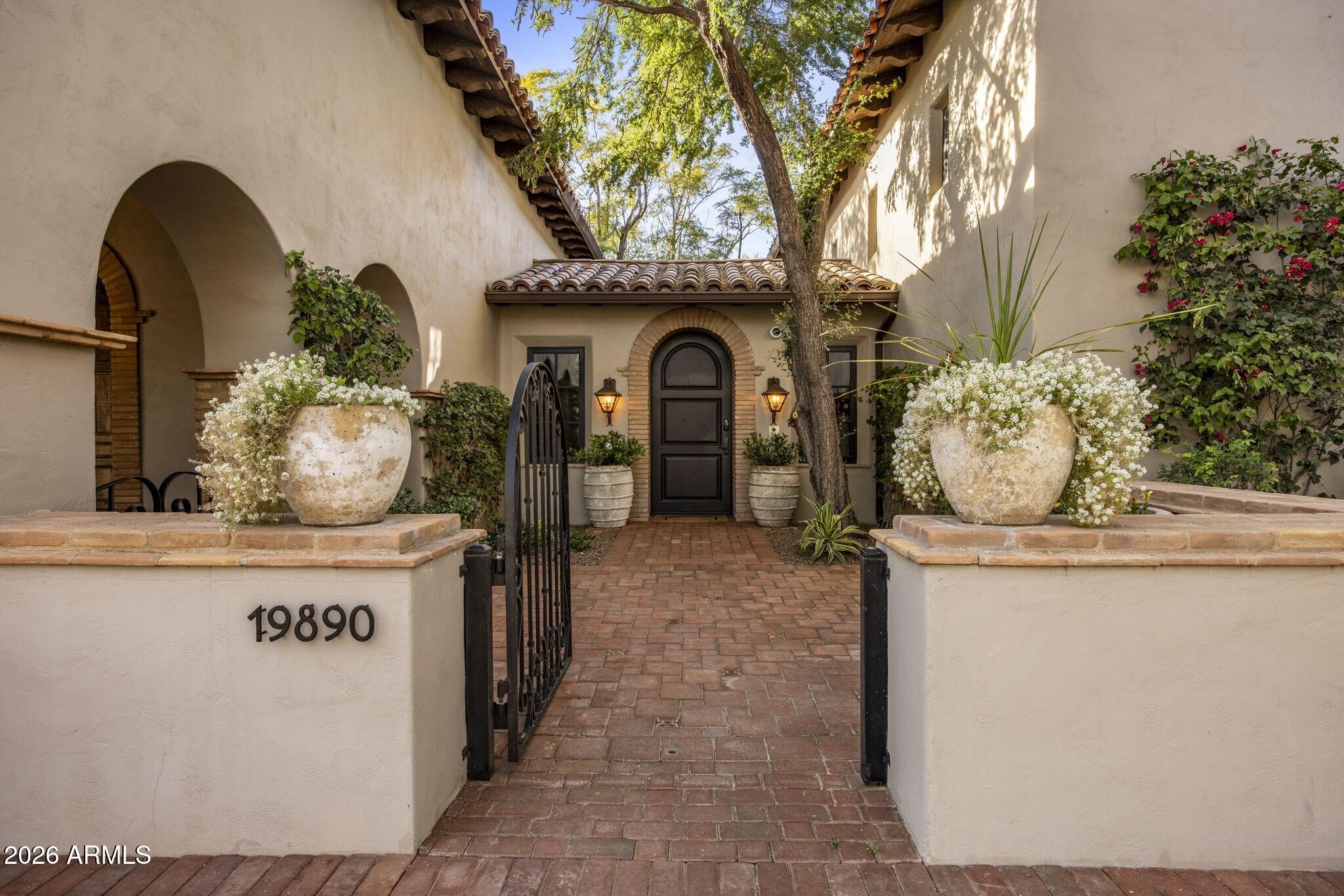Set against sweeping city light and mountain views, this exceptional estate blends timeless character with inviting charm across an expansive 8,344 sq ft floor plan. Offering 5 bedrooms, 5.5 bathrooms, a guest casita, two dedicated offices, and multiple bonus rooms, the home is thoughtfully designed for both everyday living and effortless entertaining.
A series of private courtyards create a warm, welcoming arrival and seamlessly connect indoor and outdoor spaces, filling the home with natural light and a true sense of place. Generous living areas provide flexibility for gatherings large or small, while bonus rooms offer endless possibilities for a media room, gym, game room, or creative retreat.
Outdoor living is... a true highlight, featuring a resort-style pool and spa, putting green, dog run, and tranquil courtyards positioned to capture Arizona's dramatic sunsets, mountain vistas, and sparkling city lights. The guest casita offers ideal accommodations for visitors, multigenerational living, or a private studio space.
Rich architectural details and authentic finishes add warmth and personality throughout, creating a residence with soul--gracious in design, flexible in function, and perfectly positioned to enjoy privacy, views, and timeless appeal.