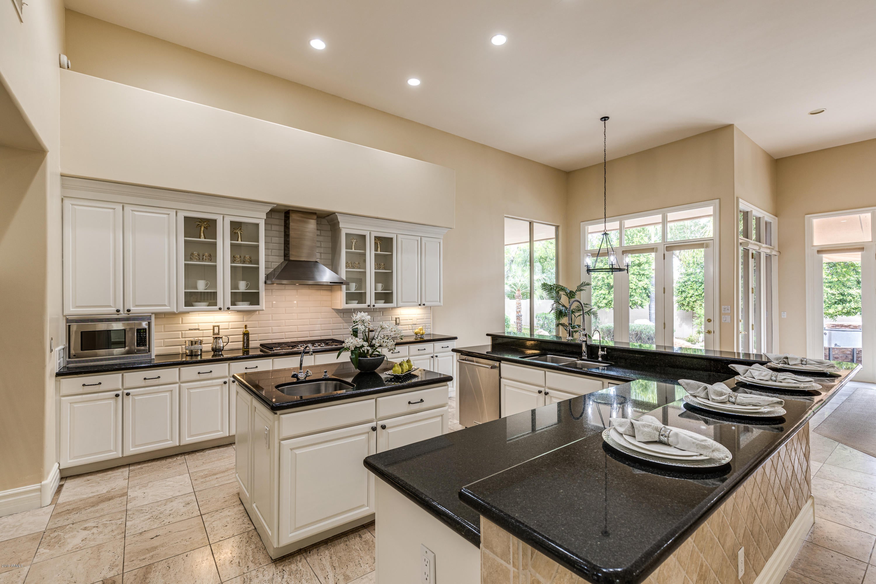 RECENT TARGETED UPGRADES-WHITE CABINETRY, FRESH PAINT INSIDE & OUT, CONTEMPORARY LIGHTING & MORE.  Spectacular Santa Barbara in premium PV location in 3C's favorite school district. Lushly landscaped with a circular drive on a N/S lot. Quality details include stone floors, high ceilings, ideal split floor plan for privacy, master suite w/sitting area, jetted tub, large walk-in shower, dual vanities/his/hers closets. A family room w/cozy fireplace opens to a chef's kitchen with gas cooktop, stainless premium appliances, large island, slab granite counters & large pantry. An office + 3 additional ensuite bedrooms with walk-in closets. A tranquil resort backyard with covered patios, sparkling pool, citrus trees and built-in BBQ is perfect for small gatherings or large entertaining! Minutes to trendy restaurants/shopping, Whole Foods, Fry's & Trader Joes.