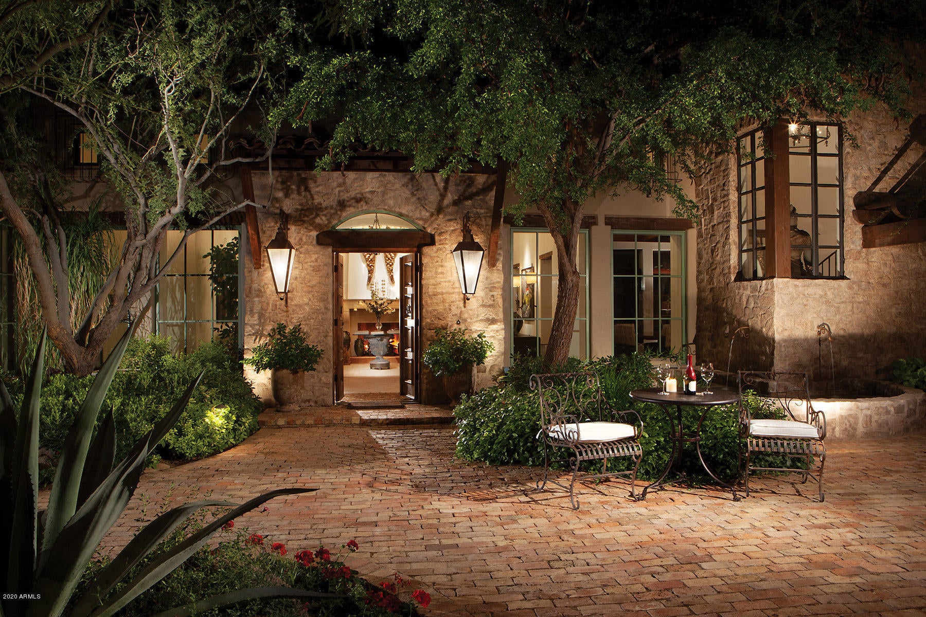 Amazing authentic craftsmanship and stunning views abound at this private 4.4 acre jewel estate, located within the highly regarded, gated enclave, The Peak.  Located on, arguably, the finest parcel within the community, this Romantic Santa Barbara home is set back from an understated private road, creating a magical arrival experience.  N/S orientation allows for sunshine-filled backyard enjoyment, including endless gardens, negative edge pool and spa, numerous firepits and breathtaking sunset, mountain and city light views.  Generous covered patio spaces create the famous Arizona seamless indoor to outdoor living experience. 6 car garage! Multiple gathering spaces from the chef's kitchen allow for casual mornings and evenings in, while the formal dining room and great room will delight a larger crowd. The private master retreat offers adjacent yoga/meditation room and outdoor soaking tub.  Two additional guest suites and offices complete the main house features.  A detached three bedroom guest casita with private baths and sitting room/kitchenette is located just steps from the main property yet affords additional privacy for guests.