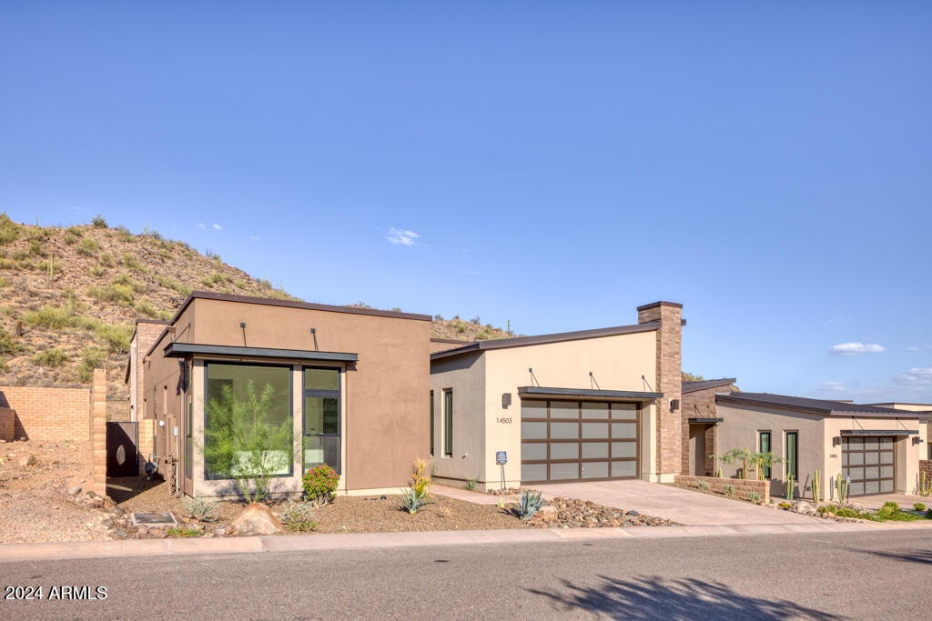 Nestled in the serene enclave of Adero Canyon in Fountain Hills, this brand-new home epitomizes upscale, ''lock and leave'' living.  Designed for those who appreciate both luxury and low maintenance, this residence offers sleek, contemporary architecture along with expansive windows and doors, creating a feeling of both privacy and views.  The residence is sited on one of the highly preferred, elevated private lots as it backs to the preserve and hills, with no neighbors behind.  High-end finishes, open concept living spaces and smart home features complete this modern oasis, making it an ideal retreat for those seeking a balance between sophistication and convenience. With two en-suite bedrooms and study/office in the main residence, plus separate entry casita and upgraded patio yard with "spool", no detail has been forgotten in this picture-perfect home!