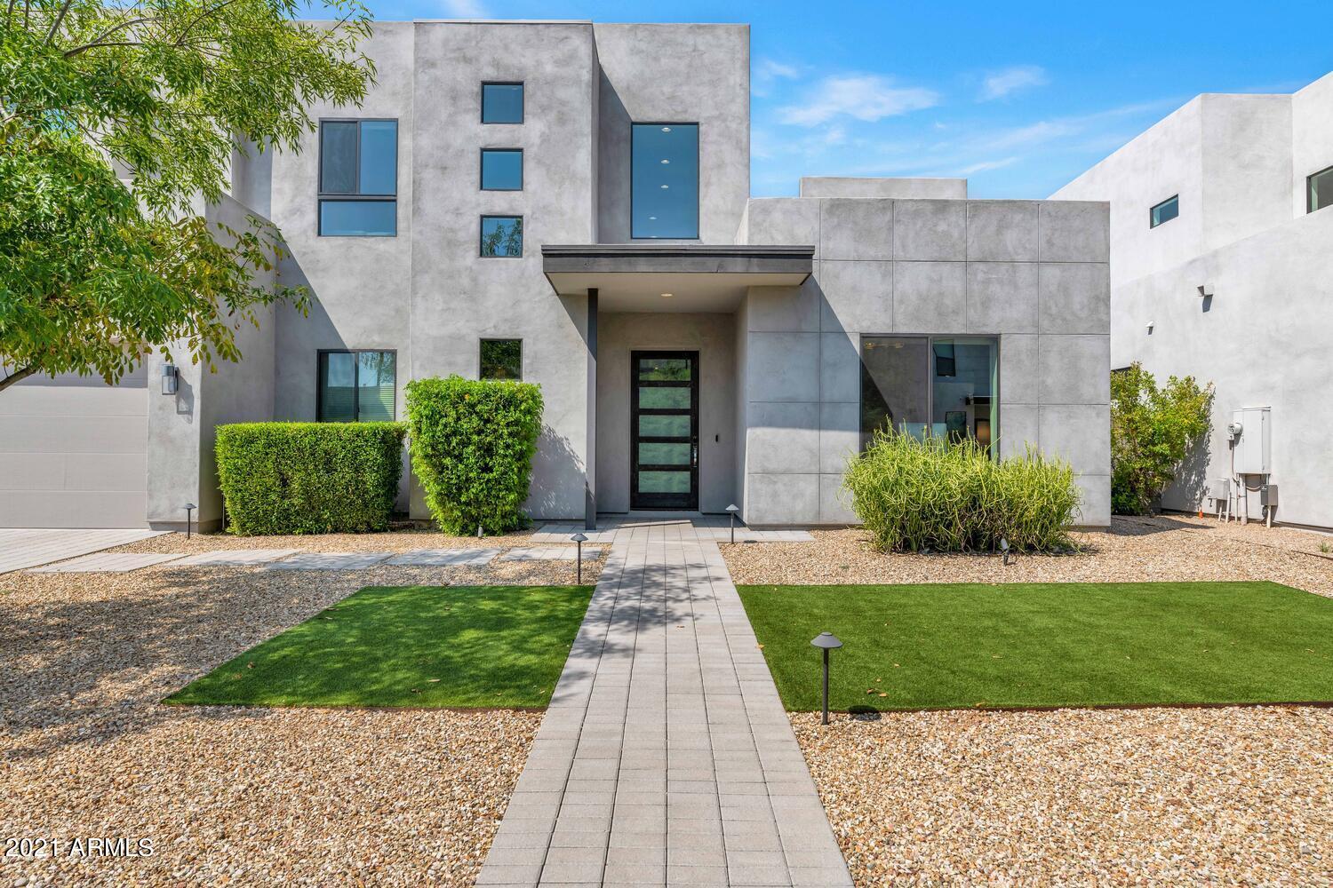 Stunning Modern Elegance in the best location of the Valley! 4 bedroom+Den, 3.75 baths,  3274 SF! Formal living room w/cozy gas fireplace opens to family room/formal dining. Gourmet kitchen features; upgraded stainless steel appliances, granite counters & custom granite waterfall island & walk-in pantry! Downstairs Master Suite with a true spa like Master Bath including dual vanities, a freestanding tub, rainfall shower head, octagon tile flooring, walk-in closet & private exit. Upstairs you will find a spacious loft & 3 large bedrooms one of which features an ensuite. The backyard features a pool/spa, built in fire pit w/custom seating area & Astro turf. 4-CAR garage includes Tesla Charger & plenty of storage space! All this and just minutes to all that Scottsdale & Arcadia have to offer!
