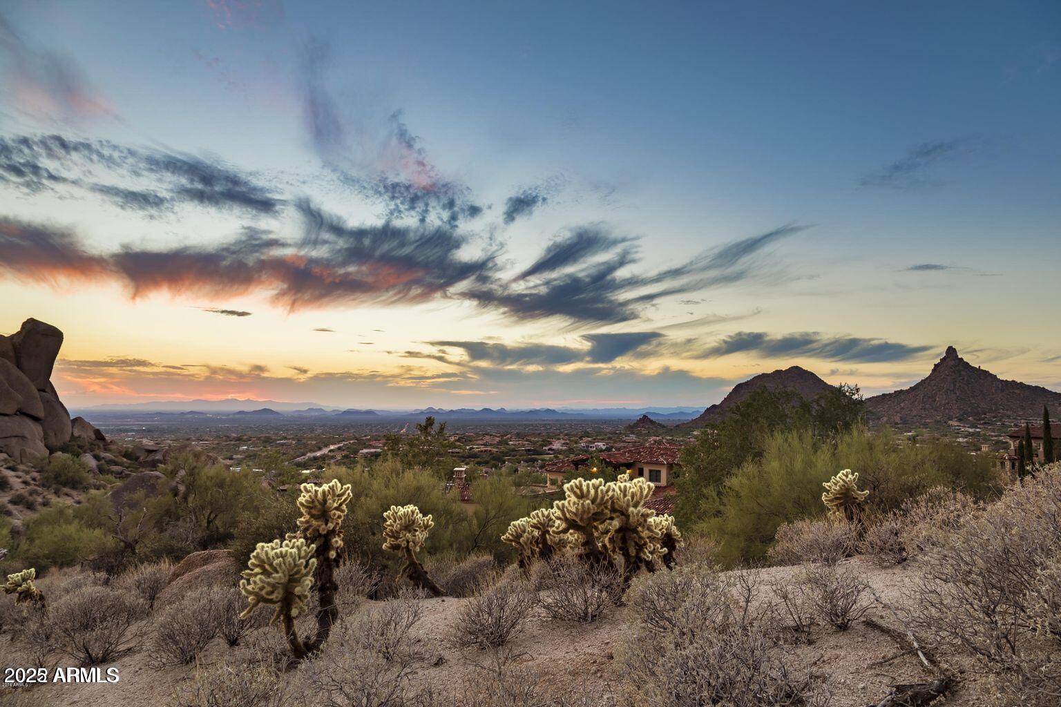 This extraordinary 2.7-acre lot sits at the highest elevation available in the exclusive guard-gated community of Artesano at Troon, nestled in a private cul-de-sac for the ultimate privacy. Architectural plans are available for a luxurious 7,256 SF home with a 6-car garage, designed to harmonize with the majestic setting of unmatched panoramic views of breathtaking sunsets, sparkling city lights, and stunning mountainscapes, including the iconic Pinnacle Peak. Just a short walk to Troon Golf Country Club and minutes away from some of the finest golf, hiking, shopping, and dining options.