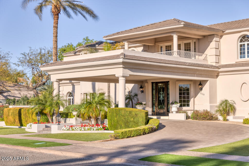 Prepare to be wowed. Welcome to an extraordinary residence in the beautiful Vaquero Drive community of Gainey Ranch, a private gated enclave nestled in the heart of Scottsdale. This estate spans over 10,000 square feet of refined elegance, offering a lifestyle of grandeur and privacy.  Upon arrival, the motor court and stately porte-cochere set the tone for an unparalleled living experience designed for both lavish entertaining and intimate family living. The home showcases timeless architecture, soaring ceilings and masterful craftsmanship throughout.  The expansive floor plan includes four luxurious en suite bedrooms, a family den, an elegant formal dining room with a wine cave, a chef-loving kitchen with double islands and a serene morning room that captures the soft desert light. The richly appointed library invites quiet reflection. A commercial elevator offers seamless access to both levels of the home although the grand dual staircases are a pleasure to ascend   There is a coach house above one garage which has a private entrance and offers the perfect living space for a caregiver or hired help.  
This private estate boasts of resort style amenities: Colorful floral beds, manicured lawns, an inviting pool, a private tennis and pickleball court and a ramada offering sun protection. As a special benefit, you will have your very own orchard of peach, apricot and apple trees among 9 citrus trees. 
For the automobile enthusiast, there are three two-car garages of which one is extended length and over-height.  These garages will easily accommodate six or more vehicles, including an RV or boat and still have ample space for storage and equipment. 
For the frequent traveler, the address offers the convenience of an approximate 12-minute ride to the Scottsdale Airport and a 25-minute ride to the Phoenix Sky Harbor International Airport.  This exceptional estate is truly a rare opportunity; it has never before been on market and is one of the area's most distinctive properties.