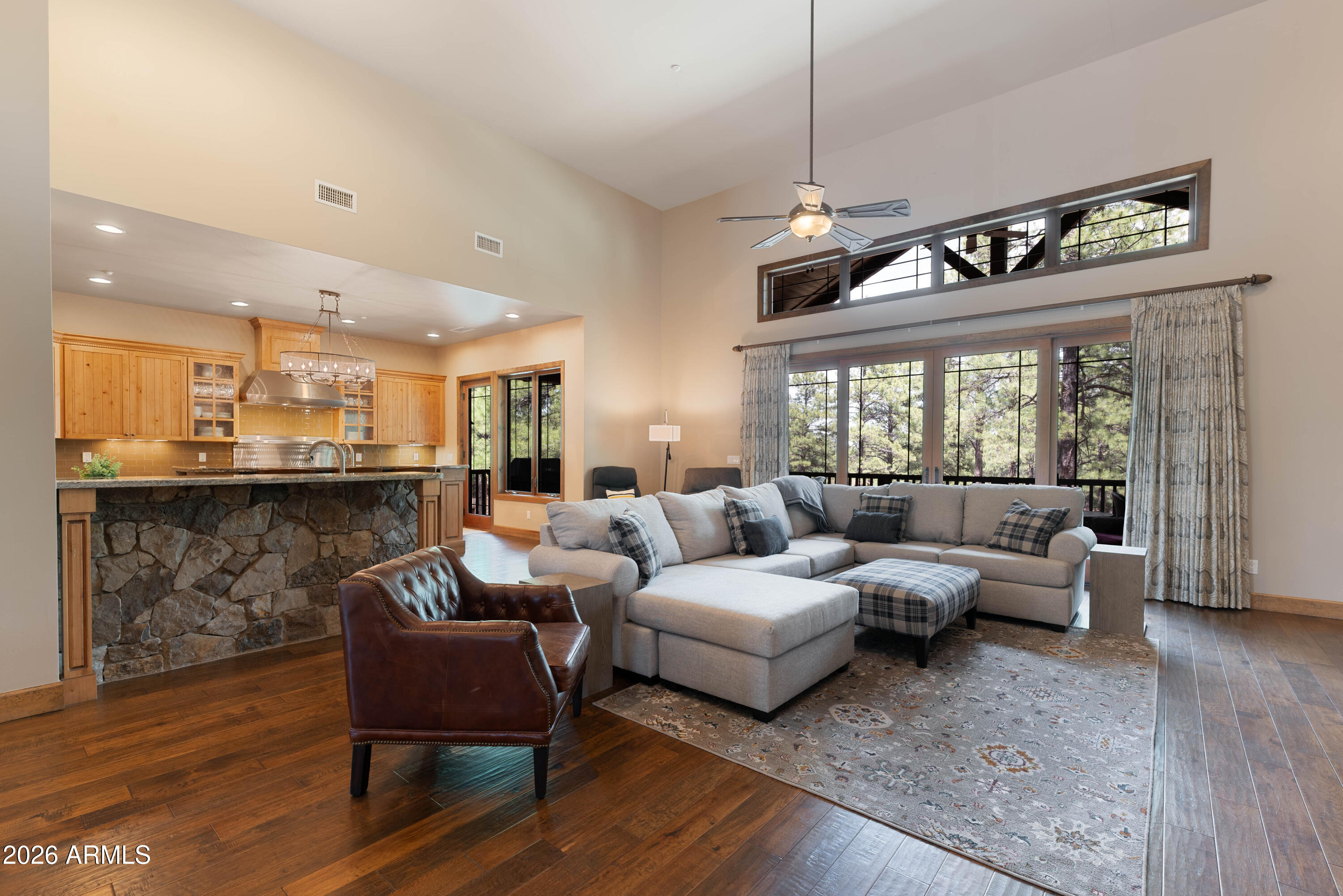 Nestled on a quiet private street within the prestigious community of Pine Canyon, this stunning single-level mountain retreat offers 4 bedrooms, 3.5 bathrooms, and 2,983 square feet of thoughtfully designed living space surrounded by towering Ponderosa Pines. Blending timeless mountain architecture with elevated finishes, the home delivers both warmth and sophistication in every detail. The inviting great room is anchored by a dramatic floor-to-ceiling stone fireplace, creating the perfect gathering space for cozy evenings and effortless entertaining. Just beyond, the gourmet kitchen is a chef's dream, featuring a custom stone-accented island, double ovens, a 6-burner range with griddle, warming drawer, and abundant custom cabinetry. A spacious butler's pantry with an oversized wine fridge provides exceptional storage and entertaining convenience, while an additional wet bar with its own wine refrigerator adds another touch of luxury.
Designed for seamless indoor-outdoor living, the primary suite offers private access to the back deck and serves as a peaceful sanctuary. The spa-inspired primary bath features separated dual vanities, a jacuzzi soaking tub, walk-in shower, and generous walk-in closet, creating a true retreat experience.
Complete with a desirable 3-car garage and tucked within one of Pine Canyon's most serene settings, this exceptional residence captures the essence of refined mountain living.