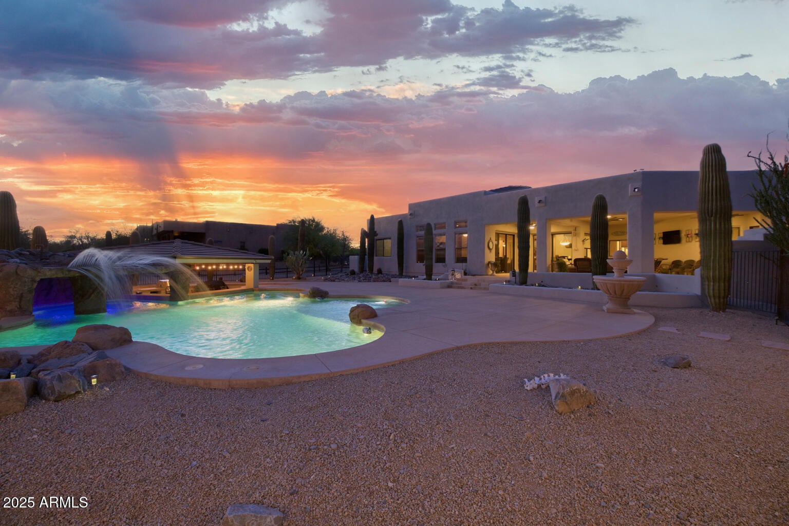 Luxury desert living experience. Set on an expansive 1.65-acre lot! Neighboring Scottsdale! Property on EPCOR CITY WATER! VIEWS for days! Across from TRILOGY Rio Verde. Featuring a fully equipped 40'x30' Workshop, generous three car garage, opulent backyard that invites year-round entertainment. Space to expand as a horse ranch!  Outdoor oasis combines privacy with breathtaking pool  dramatic cave, complemented by a swim-up bar and a state-of-the-art outdoor kitchen, an entertainer's paradise. 
Spacious, open concept kitchen and great room, both seamlessly flow to the outdoors. The oversized primary suite is a sanctuary, featuring a massive walk-in closet. This home has been beautifully refreshed with a newly painted exterior, three state of the art HVAC Every detail has been carefully considered, with generously proportioned rooms throughout the home, offering an abundance of space for relaxation and comfort. For those who appreciate the beauty of Arizona's iconic sunsets and sunrises, an observation deck above the workshop provides sweeping panoramic views of the surrounding landscape.
Equestrian enthusiasts will find a dream setup here, with three horse stalls and a large turnout area designed for both convenience and enjoyment. Located just minutes from national forests, hiking trails, biking routes, and horseback riding areas, this property offers unparalleled access to the best outdoor activities the region has to offer.
Additionally, the home is just a short drive from premier golf courses and exceptional dining options, making it the perfect balance of privacy and accessibility. This is truly a one-of-a-kind property, offering the best of Arizona living and entertaining. Don't miss your chance to own this exceptional estate.
With 97 majestic saguaros dotting the landscape, this setting is nothing short of enchanting.