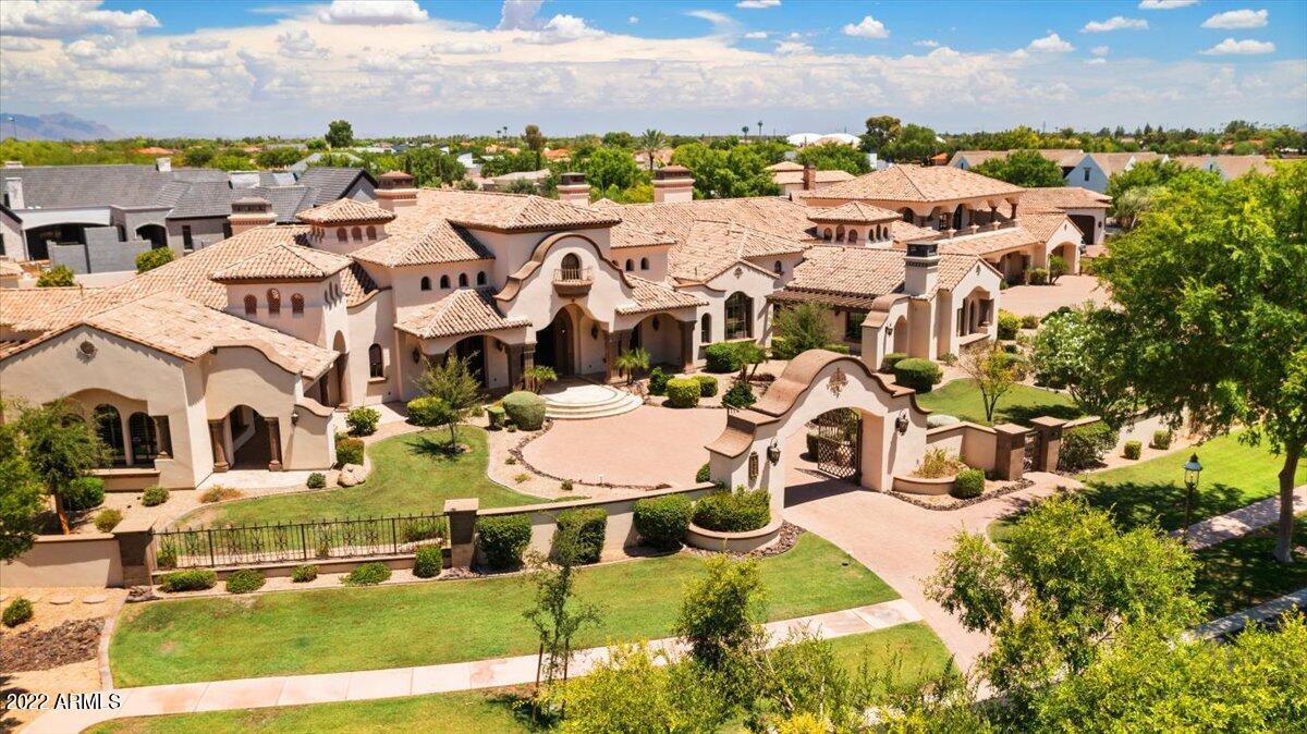 Situated on 1.7+ acres in the exclusive, gated community of Legacy Estates, this meticulously crafted custom estate offers an entertainer's idyllic resort-style living experience. The privately gated, manicured grounds provide a 12' deep diving pool, lazy river, play pool, multiple water features/fountains/slides, a heated spa, gas fire pits, an outdoor kitchen with a pizza oven, grill, built-in BBQ's, Wok Range, Yoder smoker & room to lounge under the covered patios/ramada/pergola! Expansive open floor plan presents custom ceilings throughout, an executive office, media room, game room, junior suite, a 6-car overheight garage + workshop, secluded primary suite, fitness room, it's own private patio & much more! The custom kitchen is equipped with alder wood cabinets, granite countertops - Viking stainless steel appliances, an oversized center island & 2 extra-large pantries accompanied by a beautiful breakfast nook & elegant formal dining space. Enjoy separate garage entry to the 2-level guest casita with a ground level in-law suite, 2nd level bedroom, living room, fully equipped kitchen & private balcony. Enhanced with custom wood beamed & venetian plaster ceilings, intricate woodwork, oversized windows, soaring ceilings, Cantera stone fireplaces & phenomenal handcrafted details, this residence is truly one of a kind.