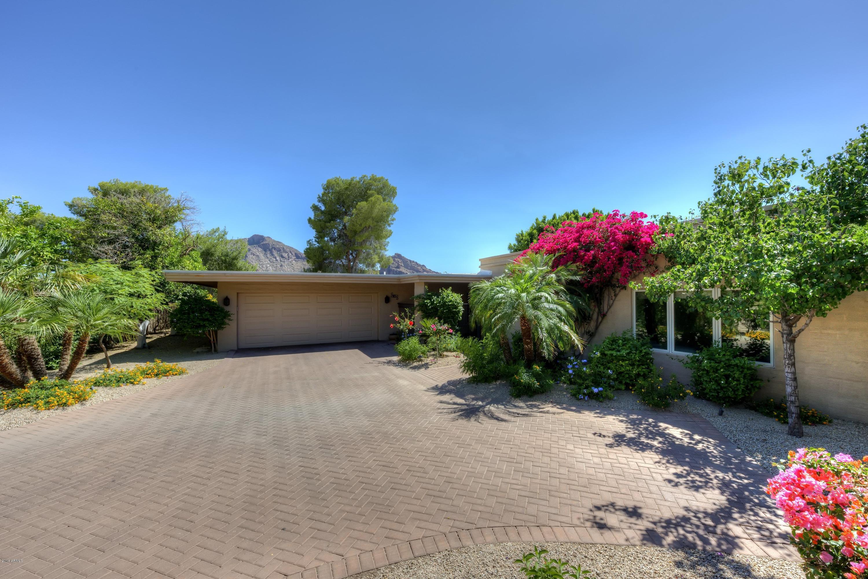 One of the most exclusive Paradise Valley 24 / 7 Guard Gated Resort Communities. Home has amazing views of both Camelback and Mummy Mountains. This remodeled 2 bedroom plus den, 2 bath home is 2,926 sq. ft. and has all new doors, windows, granite counters through out, Walnut hardwoods, beamed ceilings in L.R. w/ gas fireplace. Master bath has separate tub and shower, over sized W/I closet. Den has beautiful built ins. Eat in kitchen has corner windows with expansive views, large island, stainless appliances, walk in pantry. Two car garage with large storage room. Exterior features include: covered patio with views of Camelback. Room service available from the Camelback Inn, car service, pools, spa . Walk to the all new Lincoln Restaurant, Rita's restaurant, the R Bar, Starbucks and more