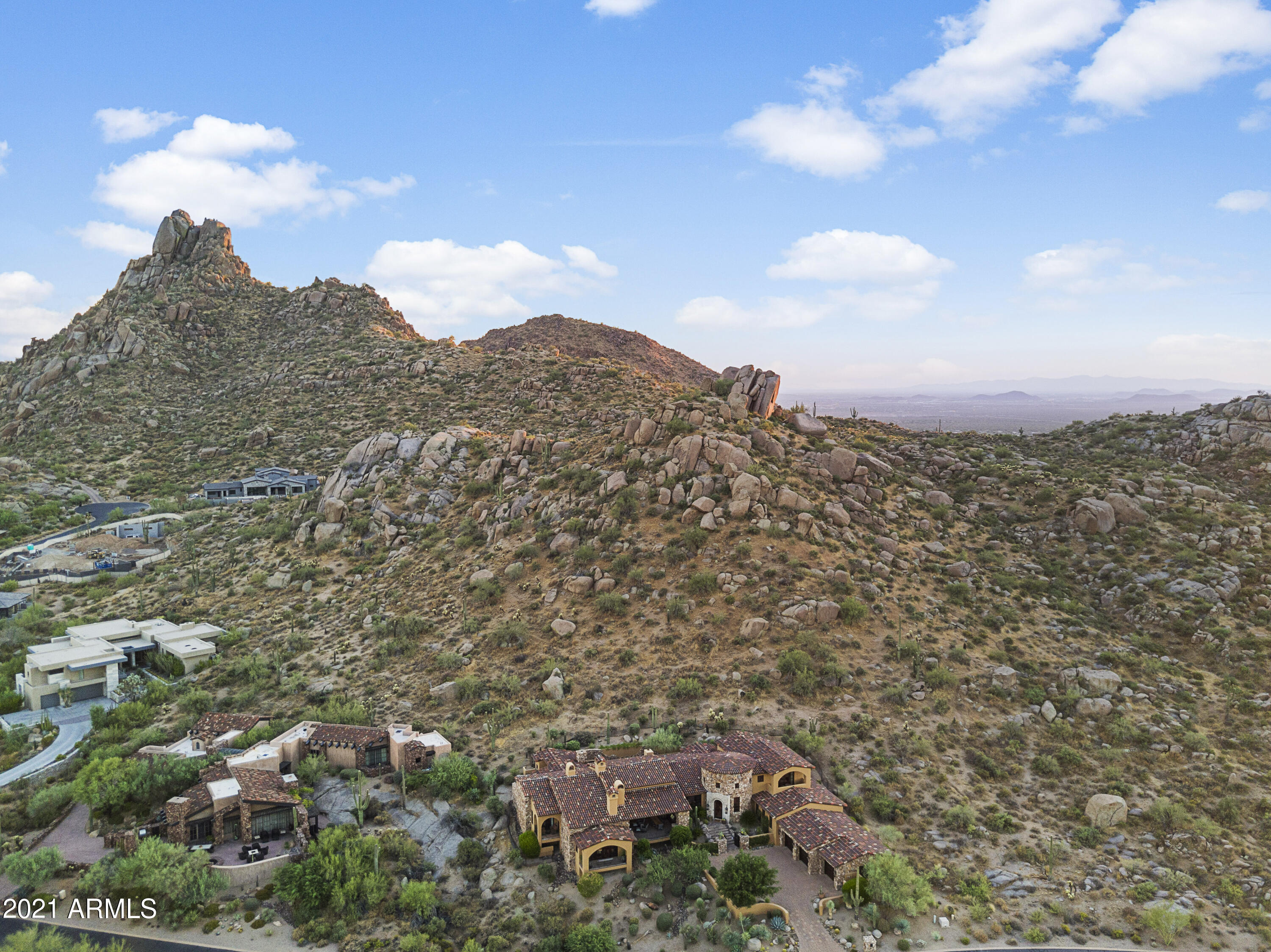 Perched high above the 16th tee of the world renowned Estancia Golf Course. This house offers unobstructed, expansive views of multiple mountain ranges on a private cul-de-sac lot. Spectacularly designed home where no detail has been overlooked. The superior finishes include real wood floors, heavy wood beams together with unique ceilings that bring out the true flavor of the old world. Enjoy outdoor living at its best on a wonderful covered patio with mountain views.  With recently remodeled kitchen, master bath/closet, flooring and updated fixtures, the home has been perfected. This 7,200+ square foot home includes private guest quarters and patio with views and second master suite.  Estancia is Golf Digest's #1 ranked course in Arizona!