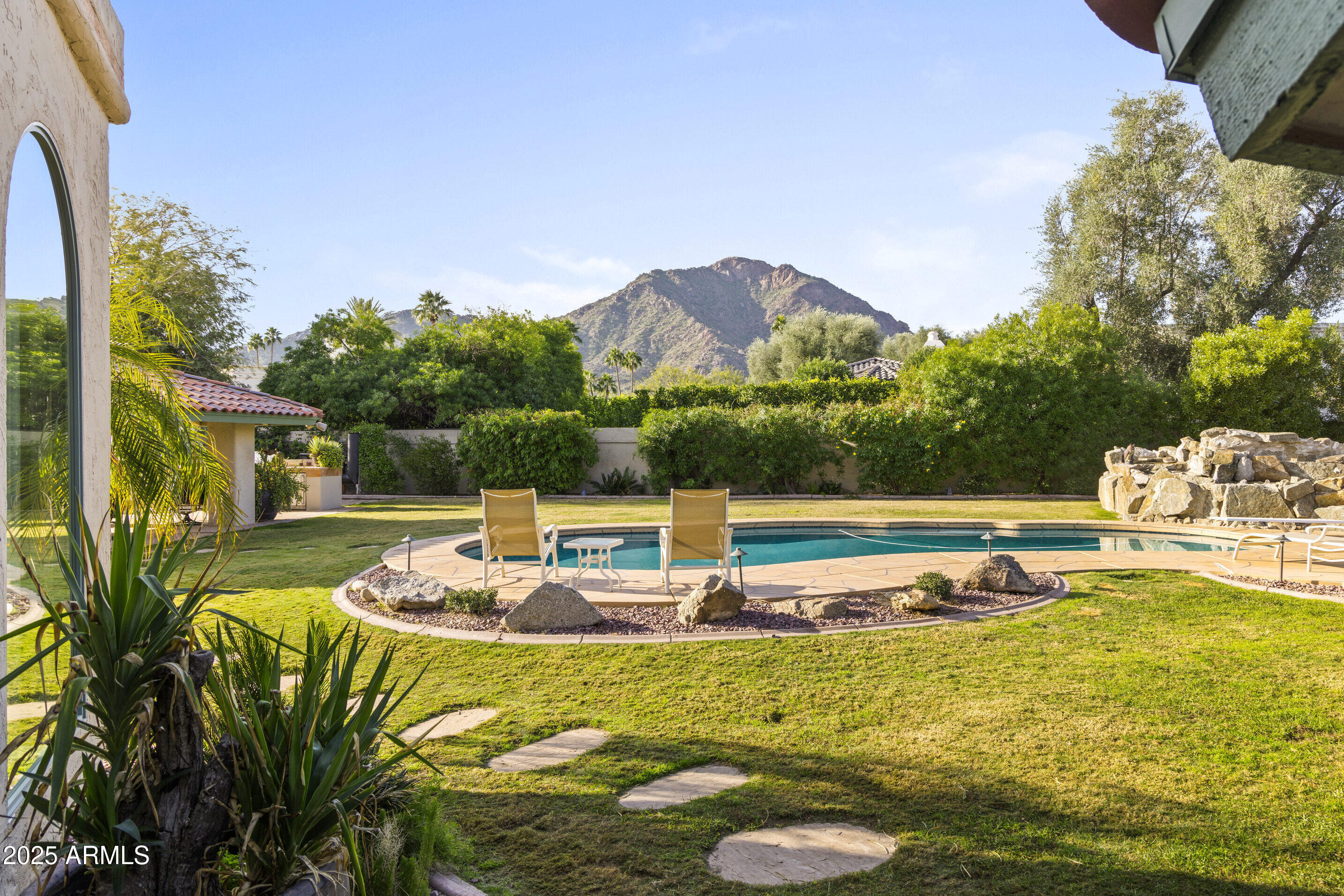 Set inside the 24-hour GUARD-GATED community of FINISTERRE, this classic Paradise Valley ranch sits in a coveted central location, capturing broad CAMELBACK MOUNTAIN VIEWS across a wide, beautifully maintained lot. The home is impeccably maintained + exceptionally livable as-is, with new roof, electrical panels, and water heaters, along with energy-efficient Pella windows. Comfortable gathering spaces include formal living & dining rooms and a spacious family room w/ high ceilings and gas fireplace. The kitchen features Sub-Zero, Miele, & Wolf appliances. The expansive grounds include a recently resurfaced TENNIS COURT lined for pickleball, pool, raised spa, firepit, mature citrus, and ramada—offering immediate enjoyment and long-term flexibility in a premier Paradise Valley setting.