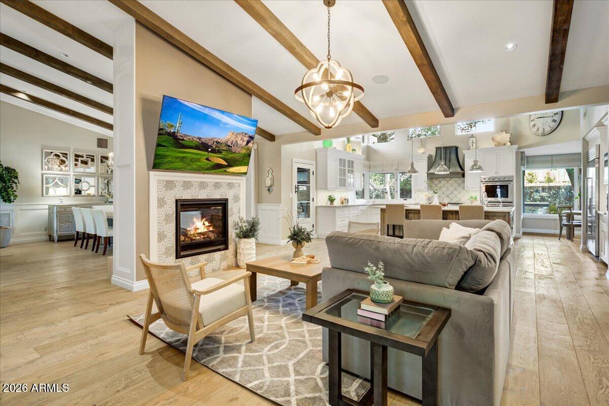 Don't miss this rare opportunity to own a 5,100 sq ft custom luxury home on a spacious .55-acre lot in the heart of North Central Phoenix. This meticulously renovated 5-bedroom home offers luxury living with top-of-the-line finishes and modern Lutron and Control 4 automation throughout. The heart of the home features a gourmet kitchen with high-end appliances, premium finishes, and an expansive island. The versatile floor plan includes a formal living room, a dining room and family room with a passthrough fireplace, a dedicated teen/kids flex space, and a charming breakfast nook. Skip the spa, the primary suite serves as a private retreat, complete with a large walk-in closet, soaking tub, steam shower, art-glass vanity, private laundry, and a personal patio overlooking a rose garden, fru trees and private garden. The resort-style backyard is designed for entertaining, featuring a pool and jacuzzi, bocce ball court, built-in grill, fireplace, and fire pit. Additionally, the driveway is striped for pickleball, and the side yard is ready for volleyball or badminton. For hobbyists, the oversized 4-car garage includes ample storage and a dedicated workshop area. This exceptional property combines luxury, space, and family-friendly living. It is a must-see to truly appreciate all the upgrades.