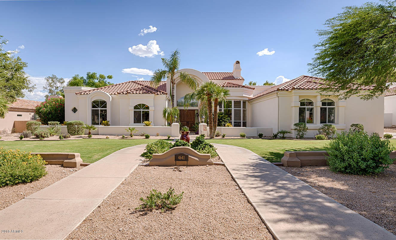 Recently updated with over $225,000 in upgrades! This pristine residence with soaring 15ft to 20ft ceilings is located on a N/S lot in privately gated Tatum Foothills within the 3 C's school district. There is a beautiful office with built-ins and all 4 bedrooms are ensuite. The children's bedrooms have 10 ft. ceilings. Opening to the  beautiful 31 ft family room is a gourmet kitchen w/new granite counters + new appliances.  The enormous master bedroom has a fireplace and large custom closet. The private backyard has a long covered patio, new travertine deck, pool & 3 cascading water features, large grass areas + a custom raised self-watering vegetable  (or flower) garden. Impeccably maintained, no steps in the home, and lots of room to accommodate a large family or to entertain!