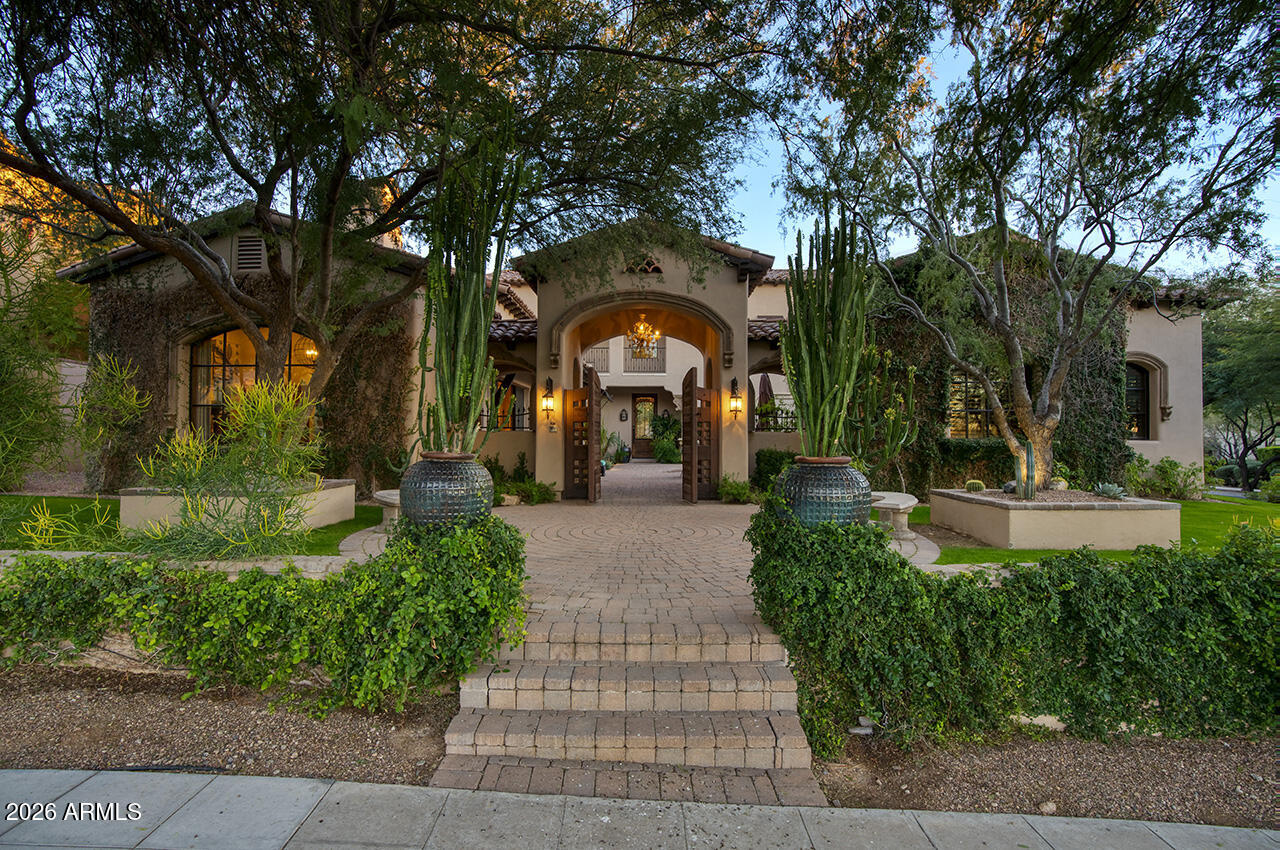 Set within the guard-gated enclave of Silverleaf Parks  in Scottsdale, this custom estate is ideally positioned on a desirable corner lot amid mature landscaping and picturesque, tree-lined streets. With two community parks directly adjacent and all eleven neighborhood parks—including a tranquil lake—just around the corner, the setting is both storybook and convenient.

Designed around a central courtyard, the home offers exceptional outdoor living with a pool, spa, fireplace, barbecue, and expansive lounging and dining areas—perfect for entertaining or everyday enjoyment—along with a separate guest casita providing privacy and flexibility.

Inside, the thoughtfully designed floor plan balances elegance and and livability, enhanced by refined finishes throughout. Wood flooring, brick and beam ceiling details, and first-class craftsmanship create a warm yet elevated atmosphere. The spacious gourmet eat-in kitchen features an oversized island with gas cooktop, Sub-Zero refrigerator/freezer, and generous gathering space. The family room serves as the heart of the home, highlighted by a striking double-sided fireplace and seamless indoor-outdoor living as it opens directly to the courtyard and outdoor entertaining spaces. The fireplace also anchors a refined library/den with wet bar, offering an inviting space for both entertaining and quiet retreat.

The split owner's suite is a true sanctuary, offering a large sitting area with fireplace, a spa-inspired bath with soaking tub, and an expansive wardrobe closetall conveniently located on the main level. An additional ensuite bedroom downstairs adds versatility.

Upstairs, two ensuite bedrooms are complemented by a generous loft with a built-in cabinet wall and access to a beautiful extended balcony. A private flex space located just off the loft provides additional versatility for a home office, media room, or creative retreat.

A special home in a truly special, park-side setting, this residence offers timeless design, elevated finishes, and thoughtful spaces within one of Scottsdale's most coveted communities.