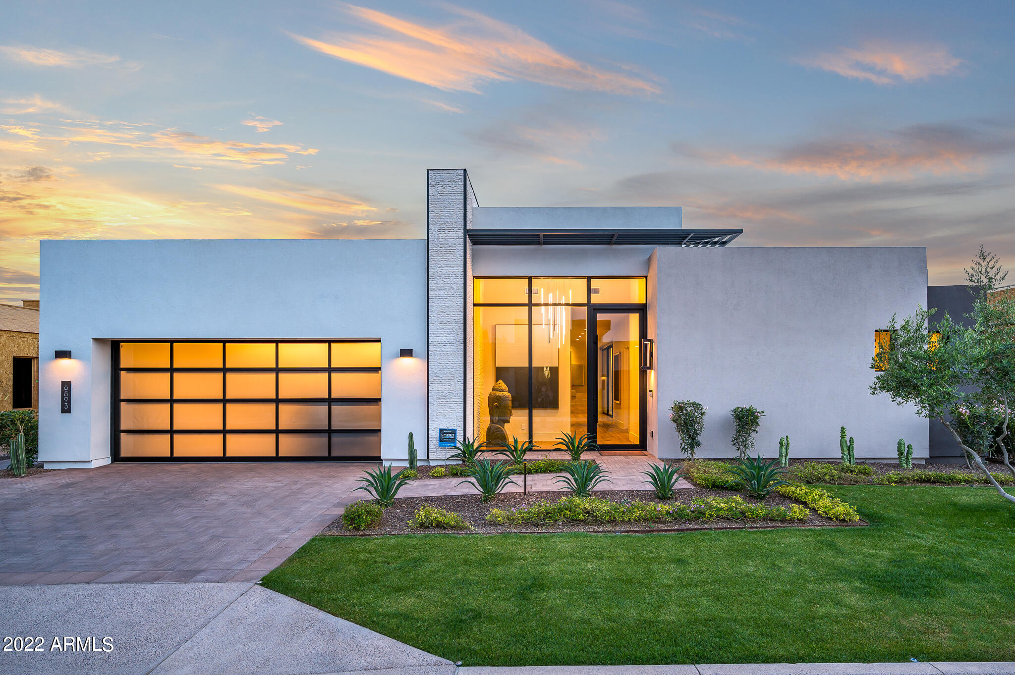 New streamline contemporary home in Azure at the Ritz-Carlton * Situated on premium homesite with South facing backyard and Camelback Mountain views * Massive sliding glass walls integrate indoor/outdoor living * Designer kitchen boasts distinctive cabinets, waterfall kitchen island, matte splash, and Gaggenau appliances * All core rooms including primary bedroom and split guest suite are located on main level; Elevator leads to light filled basement with media room, additional guest suite, and storage/sauna room * Lush outdoor living features heated pool and spa with cascading water feature, fire-pit, built-in barbecue, sit-in bar, and infrared patio heaters *