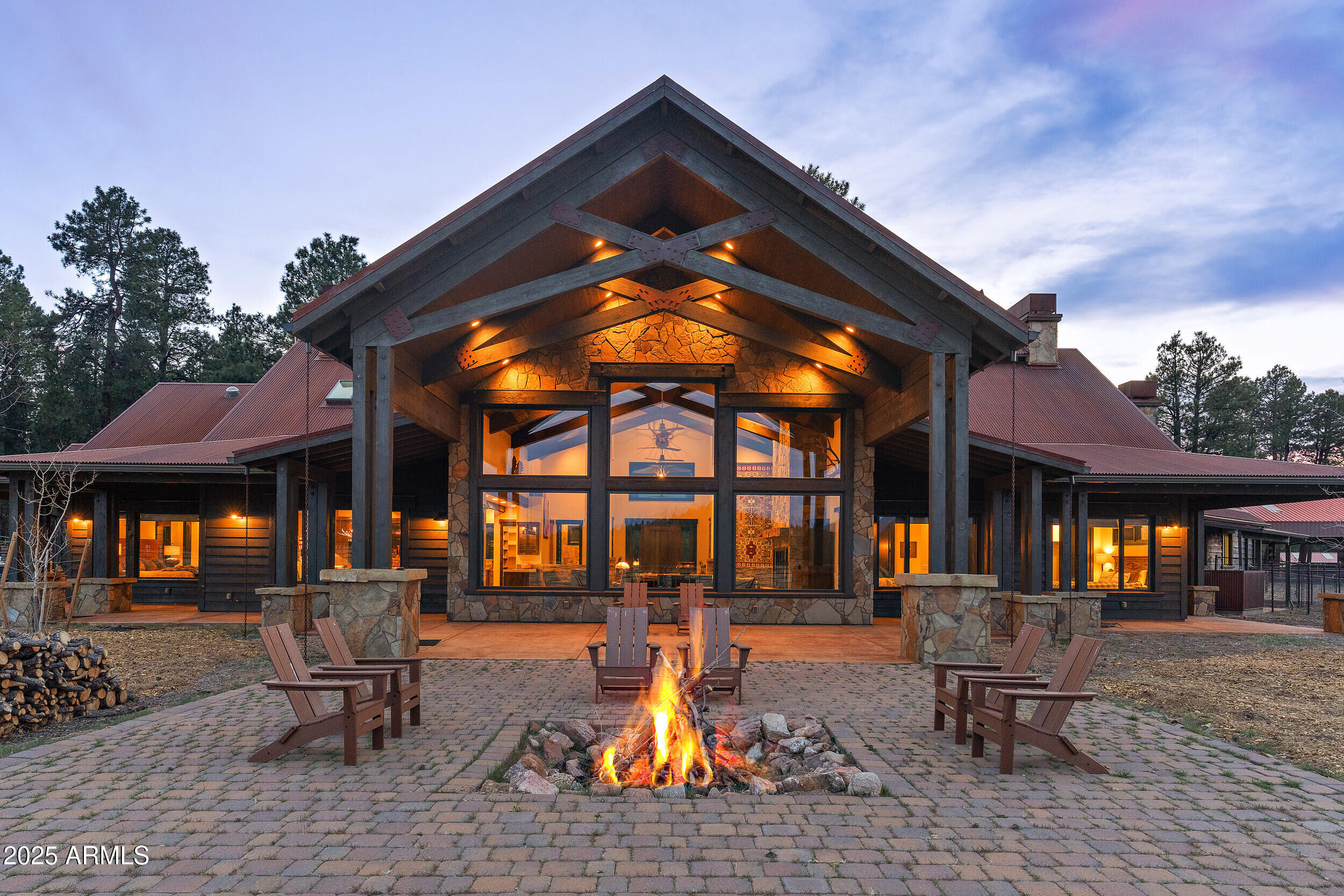 Set against the National Forest on three sides, this one of a kind mountain estate is 80 acres and captures everything you love about Northern Arizona living. The custom main home offers 4,123 sqft of living space with over 9,000 sqft under roof, blending rustic luxury with a chef's kitchen, vaulted great room, built-in custom bunk room, a porte cochère entrance, and a cozy veranda to soak in the views. A remodeled caretaker's home adds even more flexibility. Full equestrian facilities include barns, covered arena, multiple pastures, and auto waterers. Private well, pond, RV hookups, and a seasonal creek. You will be surrounded by panoramic views. Don't miss out on this legacy property.