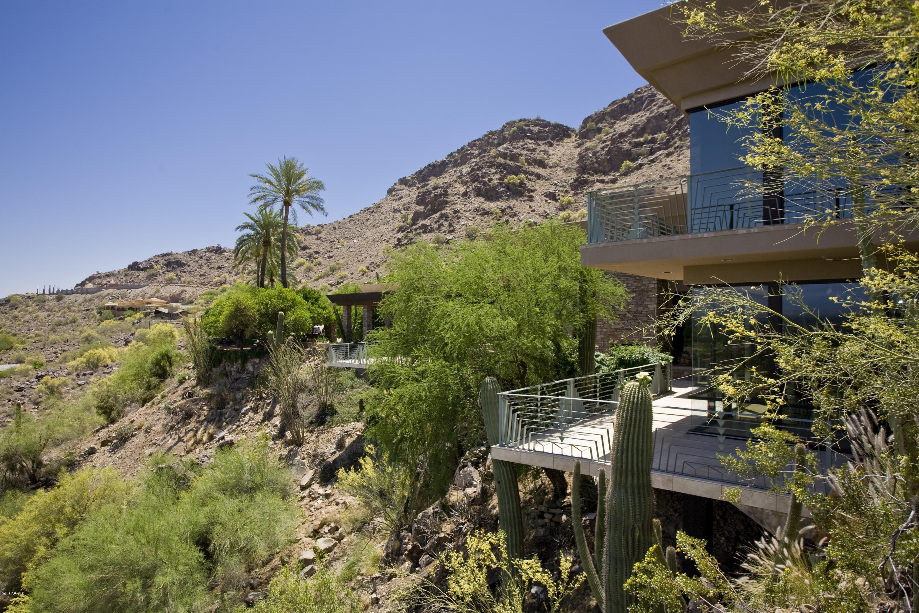 Own your Own Private Sanctuary in the Middle of the Phoenix Metropolitan area.This 12,860 Sq. ft Private Retreat is Nestled into Mummy Mountain and offers Privacy and Nature with Unobstructed Views of the McDowell Mtns. This is a LARGE **440,306 SF ** Flat Mountain Lot with 300 Ft Deep Yard Designed By Thomas Church, Which Makes it a Very Unique Property. The Home Has 7 Bedrooms, 12 Baths, 3 Living Rooms, Gourmet Kitchen,Billiards Room, Movie Theater, Exercise Room, Dance/Yoga Room, Children's Wing,Separate Guest Quarters,Office,Art Studio,RV Garage,3-Tiered Putting Green. The Interior Palette Offers Exquisite Finishes and Materials. The Asking Price is $239 Per SqFt Below Avg Listing in PV. Located in the Cherokee, Cocopah, Chaparral School Complex. Seller is Active RE Broker in AZ