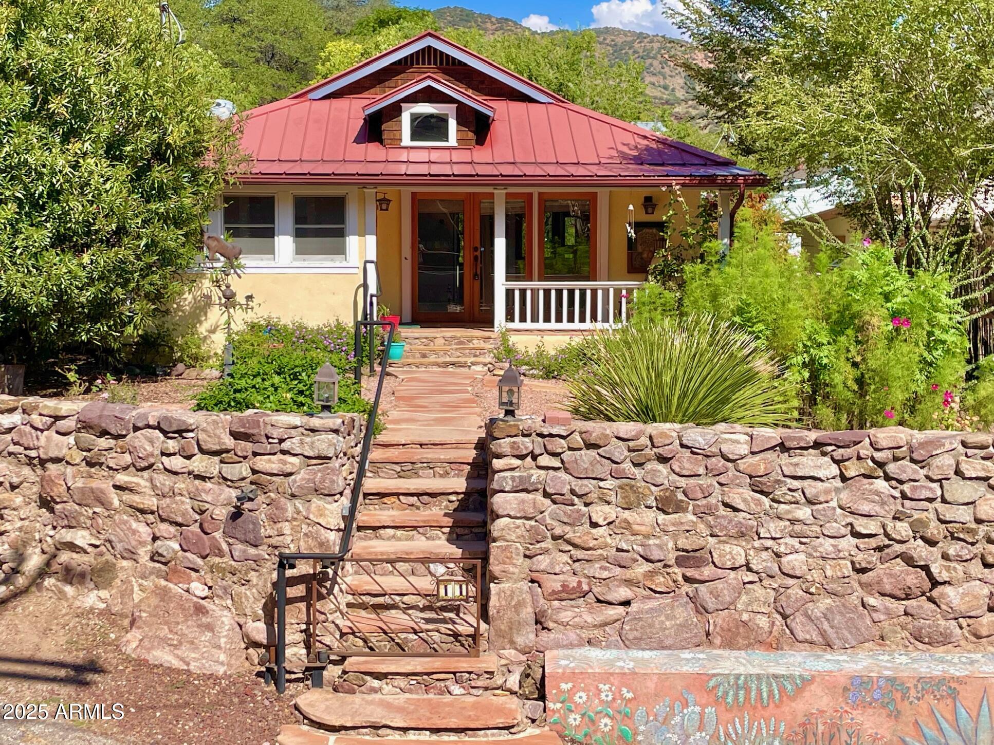 After being restored, updated and upgraded in ways that only the most discerning homebuyer will appreciate, this historic 1930's Old Bisbee stone and cement home exudes quality, durability, spaciousness and beauty! Features of this home include 3 bedrooms, 1.75 baths, vaulted ceilings, Douglas fir and Saltillo tile floors, central a/c and heat, solid wood doors, large decks and a large screened-in porch for taking in the amazing views, and quality windows, glass doors, and skylights that flood the home with light. You'll also find a storage room, rainwater catchment system, a greenhouse with water and power, and 2 deeded parking spaces out front. Remaining true to its historic nature, this home is eligible for the Historic Property Tax Discount. Buyer to verify all facts/figures.