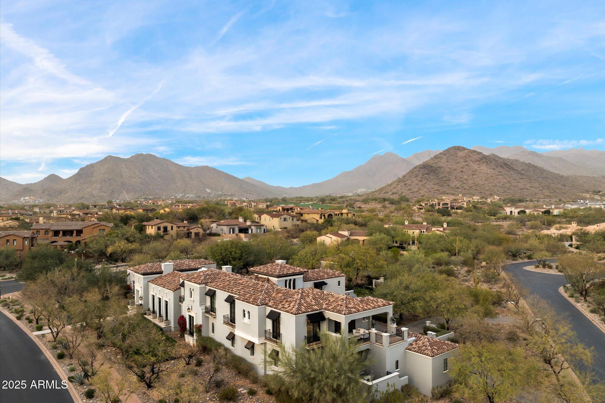 ON 1.70-acres, ample room for expansion, designed by Dale Gardon. Features sophisticated interiors by Rebecca Salcito, to include soaring ceilings, coffered details, and a soft white kitchen with a marble island, blending luxury with functionality. The primary suite is a sanctuary with dual walk-in closets, private laundry, and a serene terrace.  Expansive private outdoor spaces to include a Lap heated pool and spa, grilling station, and a covered patio with integrated heating and fireplace. Upstairs hosts five en-suite bedrooms and a lounge leading to a terrace with sweeping views. This property combines elegance, comfort and expansive living, ideal for those seeking a luxurious and private lifestyle. A must-see home.