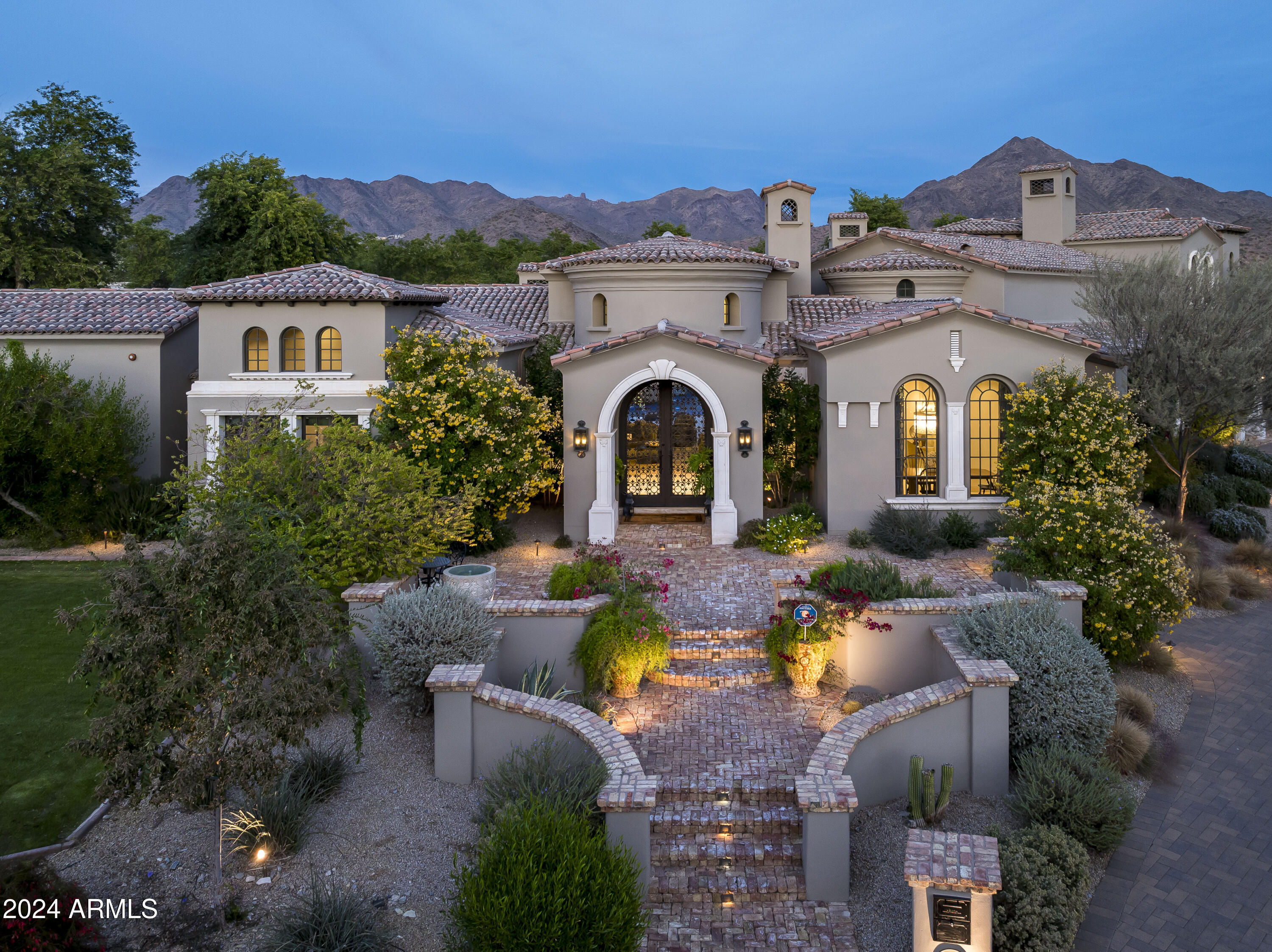 SILVERLEAF GOLF MEMBERSHIP OPPORTUNITY! 
Experience unparalleled luxury in this stunning 8,100-square-foot estate, located in the coveted gated community of Arcadia Silverleaf. Situated on a premium cul-de-sac lot with picturesque McDowell Mountain views, this residence blends timeless design with modern functionality, offering an extraordinary lifestyle for families and entertainers alike.
Step through the grand entryway and into a world of refined design. The formal living room greets you with soaring ceilings, a gorgeous limestone fireplace and exquisite architectural details. The expansive great room serves as the heart of the home, seamlessly connecting to a chef's kitchen outfitted with premium appliances, a generous island, and a sunlit breakfast nook. A chic wet bar with a custom zinc countertop and glass-enclosed wine room adds a stylish edge, ideal for entertaining in style.
For movie enthusiasts, the home offers a private theater with eight-person seating, perfect for immersive viewing experiences with family and friends.
Expansive sliding glass doors open to reveal an outdoor paradise. The backyard is a private retreat designed for endless enjoyment, featuring a sparkling resort-style pool with an impressive and thrilling water slide, a full-size sports court for pickleball or basketball, a putting green, and a fully equipped outdoor kitchen. Whether hosting large gatherings or enjoying quiet family evenings, this outdoor haven is unmatched.
The main level features a luxurious primary suite, complete with spa-inspired dual vanities, dual walk-in closets with in-suite laundry, and private patio access. A secondary ensuite, currently utilized as a private gym, adds versatility to the layout. Upstairs, four additional bedrooms with two shared baths are complemented by a large bonus room ideal for a playroom, media area, or study and an expansive deck overlooking the backyard's resort-like amenities.
Practical and spacious, the four-car garage provides ample room for vehicles and recreational gear, while the oversized laundry room ensures everyday convenience.
This extraordinary property offers the perfect balance of luxury and lifestyle in one of North Scottsdale's most prestigious communities. Don't miss the opportunity to make this home your private oasis.