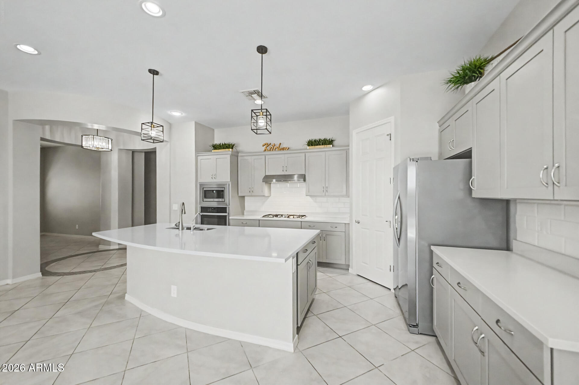 Discover this charming home with no neighbors behind! Boasting great curb appeal, this property welcomes you with a 2-car garage + attractive paver driveway. A thoughtfully designed hallway leads to a rotunda foyer, guiding you into a versatile den & inviting open common areas. The heart of the home is the stylish kitchen, featuring a breakfast bar island, SS appliances, a walk-in pantry, gorgeous cabinetry, subway tile backsplash, & ample counters. A convenient powder room w/pedestal sink adds extra functionality! Retreat to the main bedroom, offering a walk-in closet & barn sliding doors to a private ensuite w/a dual sink vanity. Easy-care backyard showcases a covered patio, artificial turf, & beautifully arranged pavers. Don't let this awesome home slip by!