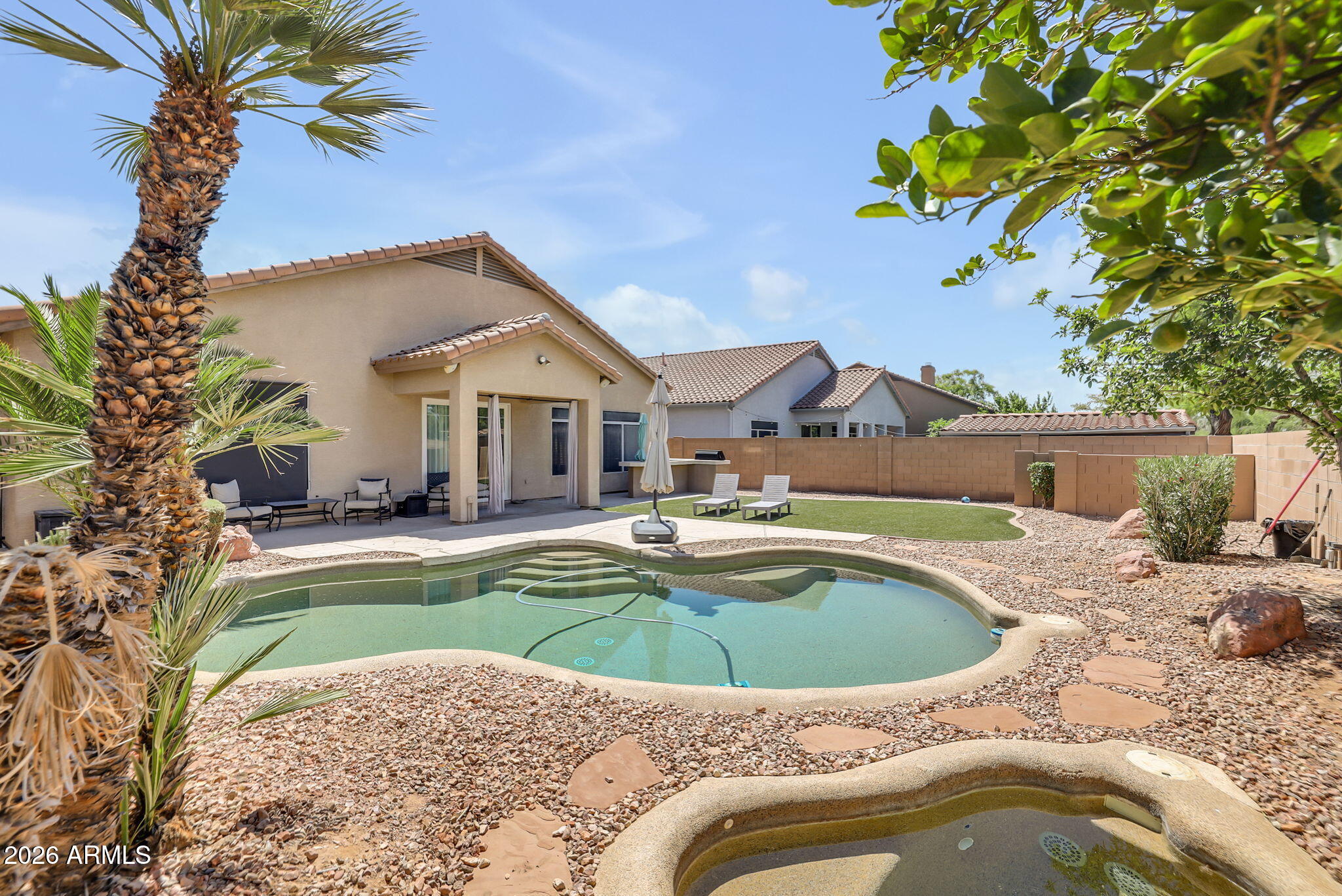 Exceptional quality and thoughtful upgrades define this beautifully maintained Chandler home with an oversized 2-car garage, resort-style pool and spa, and a highly desirable split floor plan. From the moment you enter, the home feels open, bright, and refined with plantation shutters throughout, spacious living areas, and seamless indoor/outdoor flow designed for both elegant entertaining and comfortable everyday living. The gourmet kitchen is sure to impress even the most discerning buyer, featuring granite countertops, stainless steel appliances, gas cooktop, wine refrigerator, breakfast bar seating, and abundant prep and storage space.
The private primary suite offers a true spa-like retreat with a custom oversized walk-in shower, floating vanity, lighted mirror and an expansive.... walk-in closet. Secondary bedrooms are generously sized and thoughtfully separated for privacy and flexibility.
Step outside to a meticulously designed low-maintenance backyard oasis complete with a Pebble Tec pool and spa, built-in BBQ with new grill, turf area, and lush yet easy-care landscaping -- ideal for entertaining or quiet evenings at home. The oversized garage offers built-in cabinetry and exceptional storage rarely found in comparable homes. Located in a prime Chandler location within the highly acclaimed Kyrene School District, and just minutes from upscale dining, shopping, entertainment, I-10, and Loop 202, this home combines luxury, convenience, and timeless appeal.