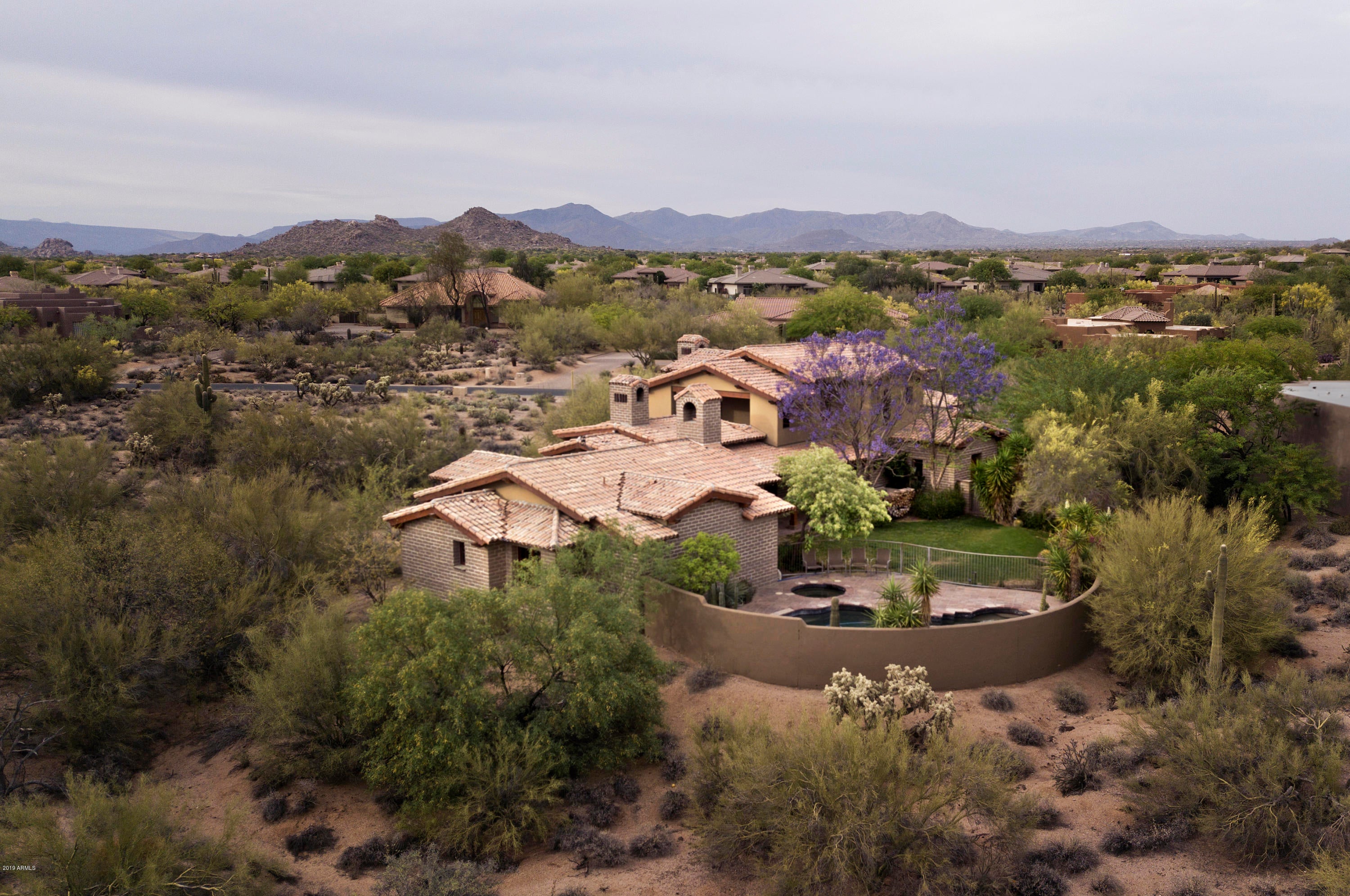 Turn back the years, when life was simple & REAL & AUTHENTICITY experienced! Beneath the veil of Lone Mountain, this exquisite Adobe Villa, 4bd+den/office plus 2 bonus-rm, was built with architectural elegance, craftsmanship & unsolicited sophistication. Hand laid one by one, the 50lb-16 inch thick adobe bricks make the walls of the house a nightmare for the huffing & puffing big bad wolf. Relax into the security of this green home with ample space for entertainment, play, or even work.  Each Taliesenesque space opens up to its own world.  Settle in as time slows down & you may never want to leave.  Multiple fireplaces, solid hardwood floors, selected travertine, impressive granite, SS appliances, and tailored cabinets & doors, make this home the epitome of charm & taste. Enjoy off the chart curb appeal, porte-cochere, views, southern exposure, and heated pool & spa as the final few top-notch touches to complete this marvelous estate. Your respite & pampering begin.

***Please note there is Video & 3D Tour (Matteport) available for your convenience.
