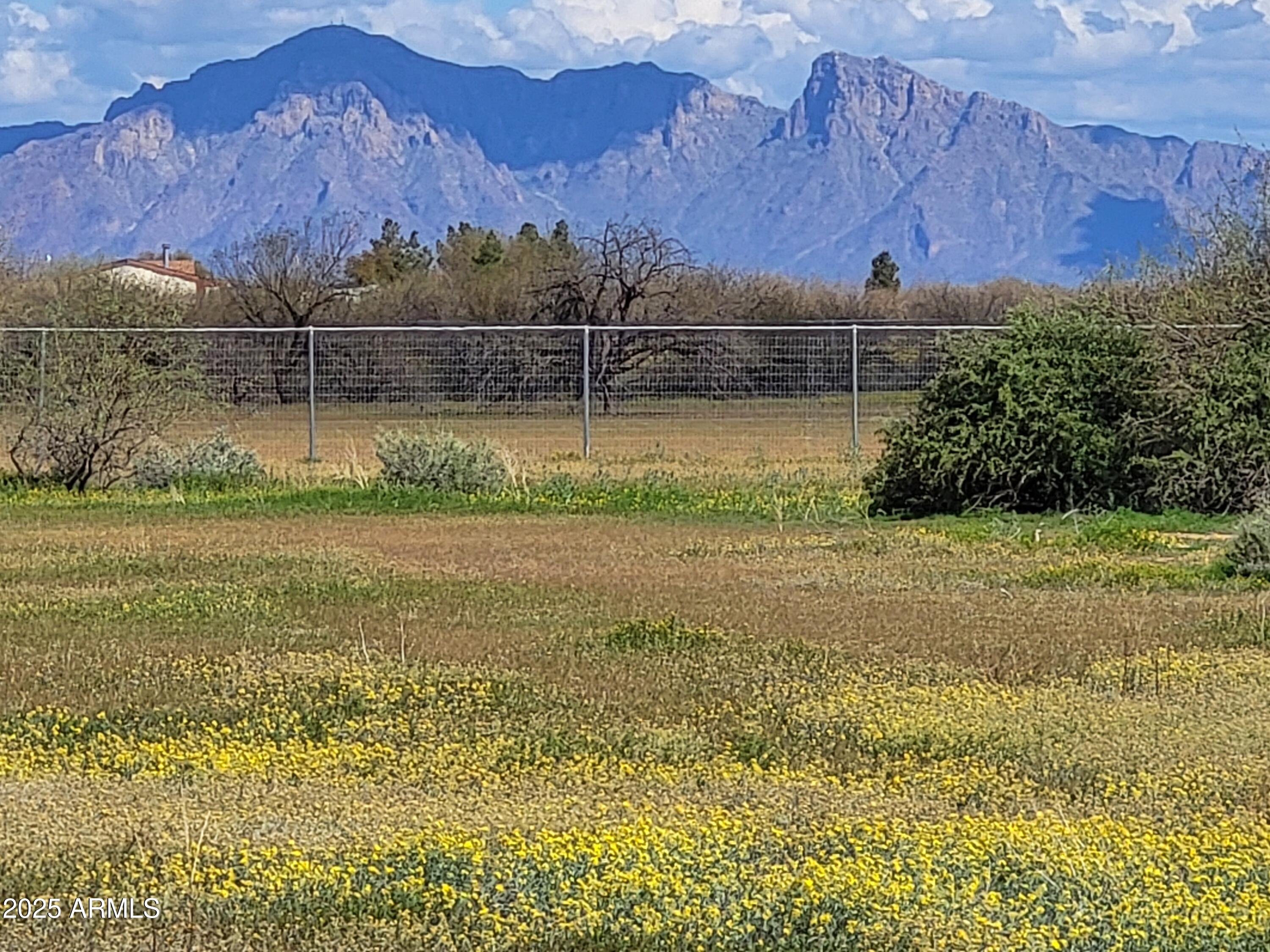This is a completely TURNKEY property!!  Close to all of the manufacturing in the area such as Lucid, Kohler, Frito-Lay and Nikola, but far enough away for peace and quiet.  Surrounded by mountain views, no HOA, this property is completely fenced with no climb horse fencing and has power AND water on the lot!  The well is brand new and under warranty.  The owner owns the 2 other surrounding properties also up for sale, so you could purchase more than one lot for family and friends (see MLS No's: 6865249, 6865278).  This property is ready to build your new home either site build or a manufactured home.  Also great for a developer!!  The owner will carry, and the terms are negotiable.  The well agreement is already recorded to ensure easy financing.