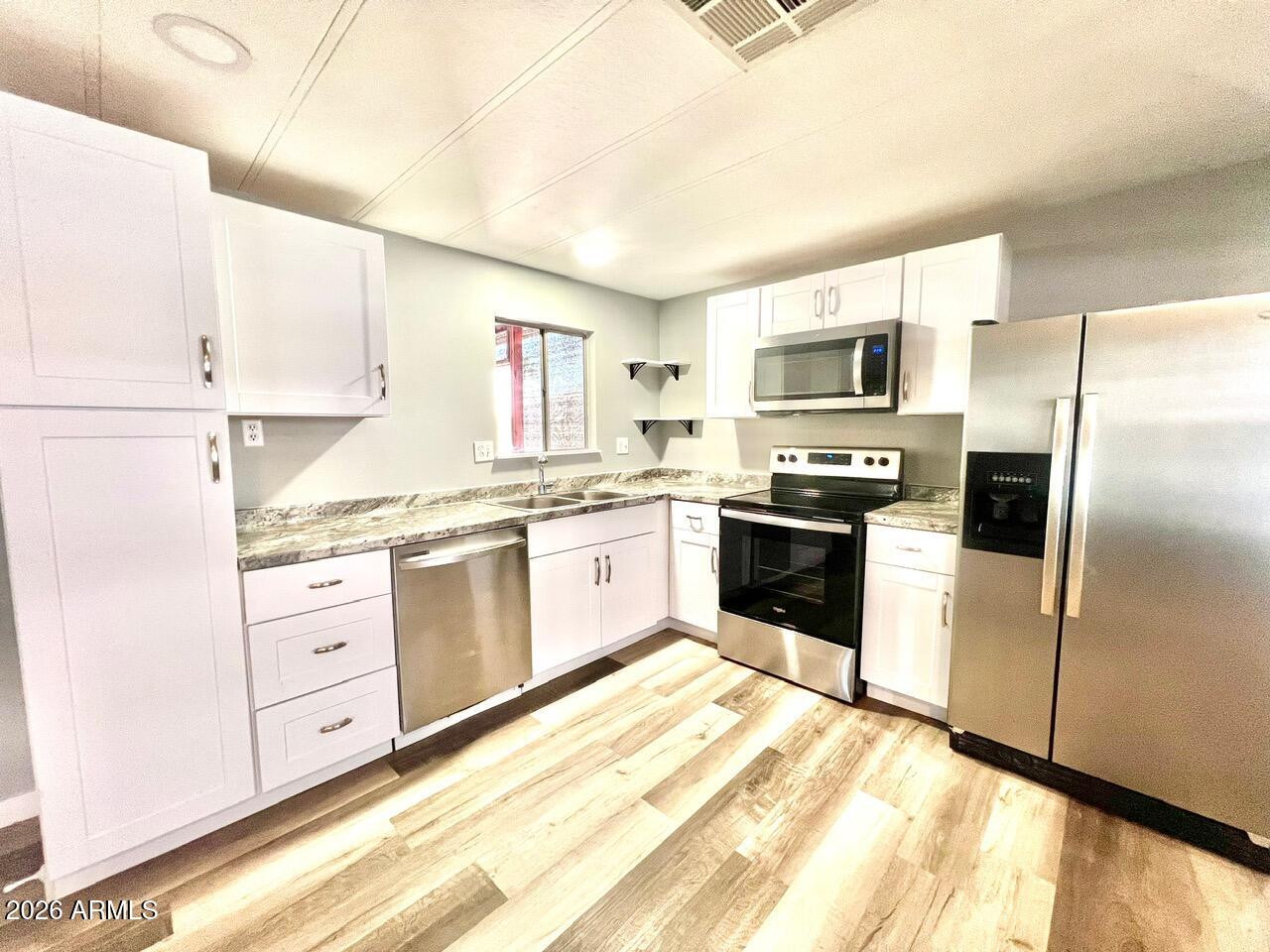 Move in ready and beautifully maintained home located in the desirable 55+ community of Sevilla Sol Community. This home offers comfortable and affordable living with access to wonderful community amenities including a clubhouse, pool, and social activities. Home offers new kitchen, new baths with tile, waterproof flooring throughout, new plumbing and updated lighting; a garage and a screened Arizona room.  Desired open and split floor plan.  This well maintained community has lots of updates coming up with a new pool, spa , pickleball, dog park. Enjoy peaceful living while being conveniently located near shopping, dining, and medical services.

Community approval required. Monthly lot lease applies.