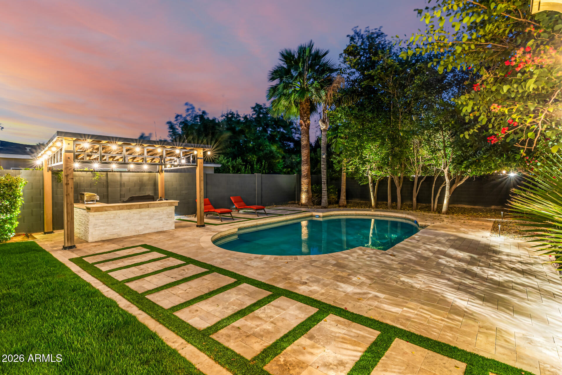 Enjoy space, charm, and location all in one! This stunning ranch-style property with POOL sits on an oversized corner lot in a premier North Central Phoenix neighborhood. Providing 4 beds, 4 baths + powder room, RV gate, 2.5-car garage, lush mature professionally landscaped w/shade trees, & great curb appeal w/paver circular driveway. The interior exudes elegance throughout with high-end finishes! The functional open floor plan features a two-way fireplace and custom folding doors that open entirely, transforming the space into an indoor-outdoor retreat. The remodeled gourmet kitchen boasts new SS appliances, granite counters, mosaic tile backsplash, a walk-in pantry, recessed lighting, white cabinetry w/crown molding, and a butcher block island w/breakfast bar. Split bedroom floor plan with all bedrooms have ensuites! The primary bedroom has outdoor access and a lavish bathroom with dual sinks & separate tub/shower. Experience a RESORT-STYLE retreat right from your spacious backyard! You'll love the relaxing covered patio, Sonos sound system for both inside and patio and a sparkling pool for year-round fun. Enjoy gardening in the beautiful travertine raised garden bed and a gazebo with power. This is your DREAM home you've been looking for! Seller recently reinspected sewer system and replaced older section beneath the garage. Don't miss this opportunity!