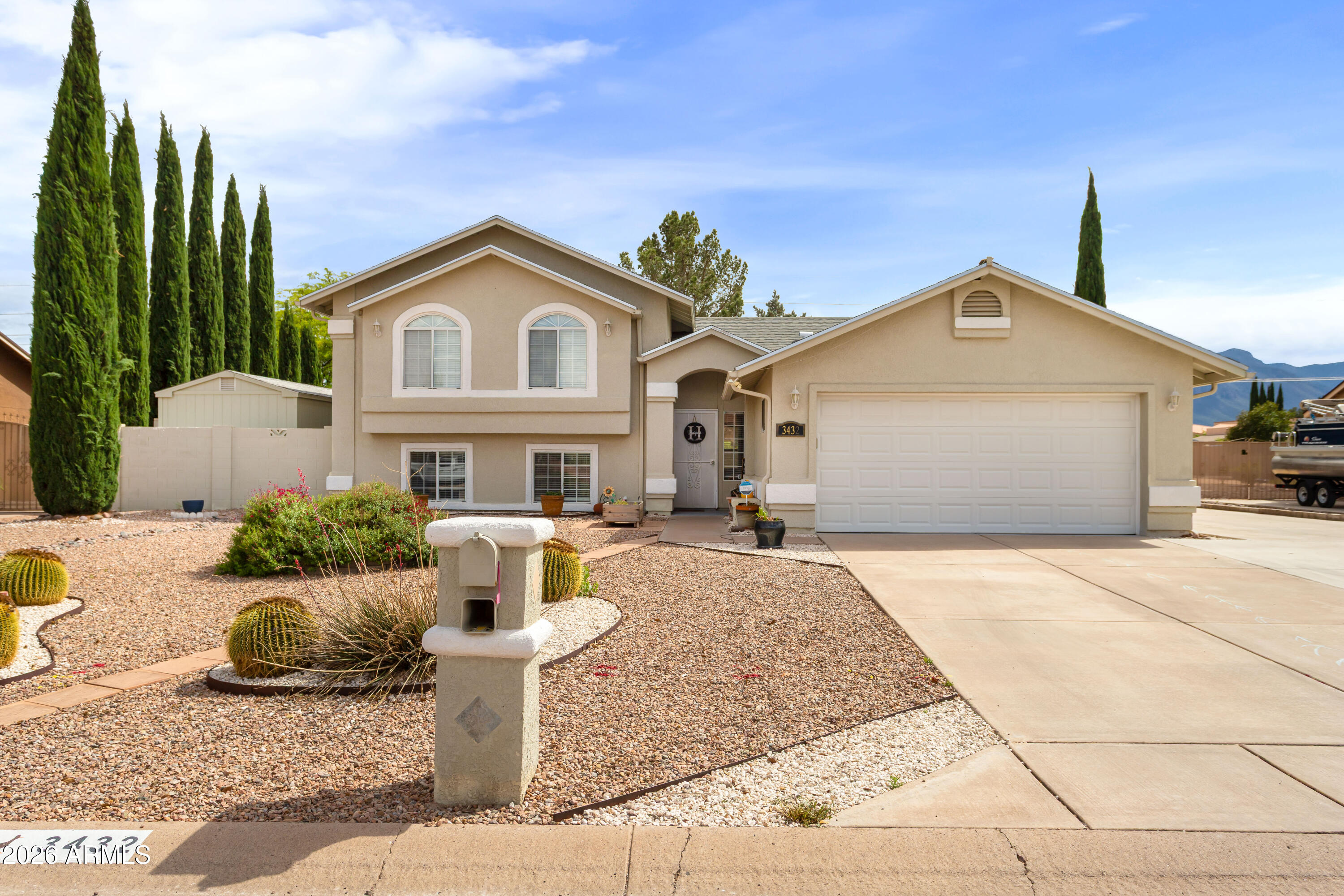 Rare opportunity in Country Club Estates! This well-maintained tri-level home offers 5 bedrooms, 3 bathrooms, and a versatile layout ideal for multi-generational living. The main level features a bright living area, formal dining, and an upgraded kitchen with granite countertops, stainless steel appliances, and a breakfast nook. Upstairs includes 3 bedrooms and 2 baths, while the lower level offers 2 bedrooms, a full bath, and a spacious family room. Situated on a large lot, the backyard is enhanced with mature trees and shrubs, creating a private space perfect for families and pets. Enjoy a covered patio with mountain views. Two sheds wired for electric (connection needed) offer great potential for storage or a workshop.