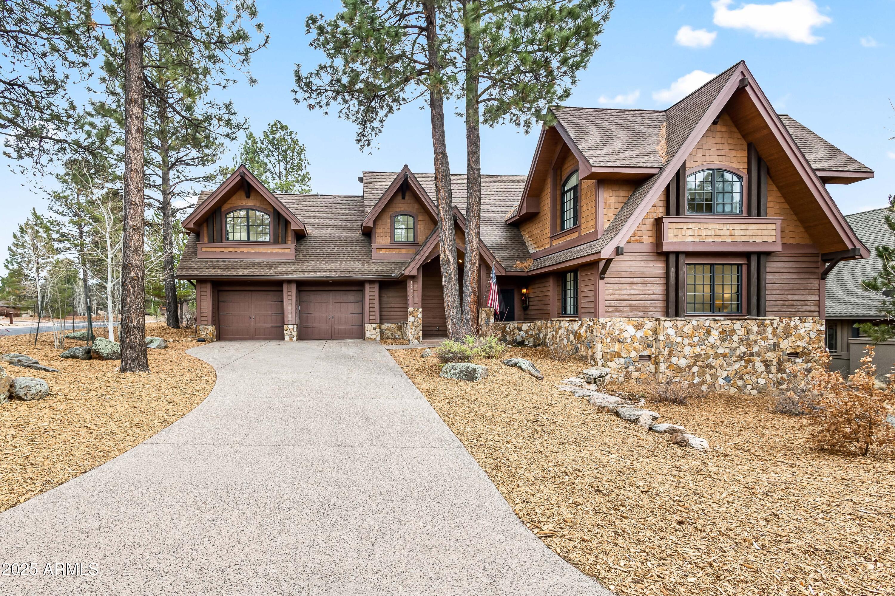 Discover mountain living at its finest in this beautifully crafted custom home nestled in the prestigious Pine Canyon community. Located on a quiet cul-de-sac, this home offers serene privacy, stunning golf course views, and luxurious indoor-outdoor living in the heart of Flagstaff. Newly renovated, enter to soaring wood-beamed ceilings, expansive windows, and rich hardwood floors throughout. The open-concept great room is centered around a grand stone fireplace and flows seamlessly into the chef's kitchen, complete with high-end appliances, custom cabinetry, a large island, and a walk-in pantry. The spacious main-level primary suite offers a spa-like bathroom, fireplace, and private patio access. Add'l 3 en-suite bedrooms, large bonus room, and 2 car garage. Enjoy cool mountain evenings on the expansive covered deck with built-in BBQ, gas fireplace, and tranquil forest views. Just minutes from downtown Flagstaff, hiking trails, and Pine Canyon's world-class amenities including golf, fitness, dining, and more. Whether you're seeking a full-time residence or seasonal escape, this turnkey home blends rustic elegance with modern convenience.