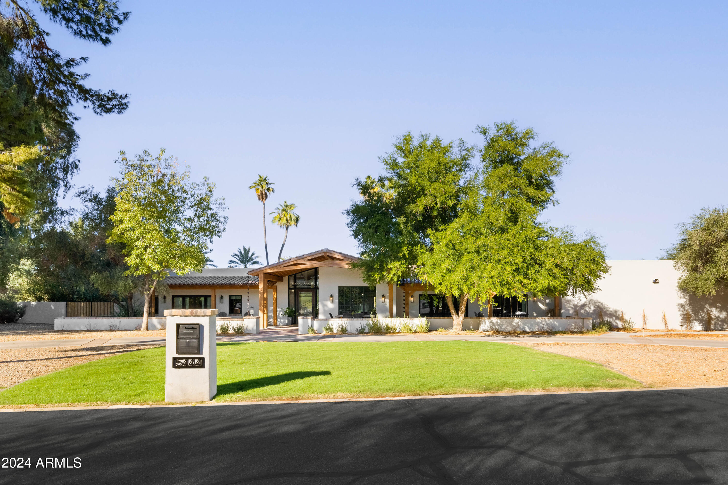 Nestled on an expansive 1-acre lot in beautiful Paradise Valley, this stunning residence is an entertainer's dream, with an array of luxurious amenities and a fabulous guest house.  Designed for ultimate functionality, the 4,855 square foot main house, has a split floor plan with 4 en-suite bedrooms, an office, a playroom and a gym. Beautiful white oak flooring throughout and a clean design, make this home warm and timeless. The attached 2,296 square foot guest house, was recently remodeled, with a full chef's kitchen, living room, bedroom, bathroom, laundry and movie theater- perfect for hosting guests and entertaining! The backyard is built for nonstop entertainment with a large pool, spa, sport court, firepit,  in ground trampoline and batting cage.  Located in one of Paradise Valley's most coveted areas, this home is just minutes from top-rated schools, world-class golf courses, shopping, and fine dining. Don't miss out on a property that embodies the best of Arizona luxury living in a prime location!
