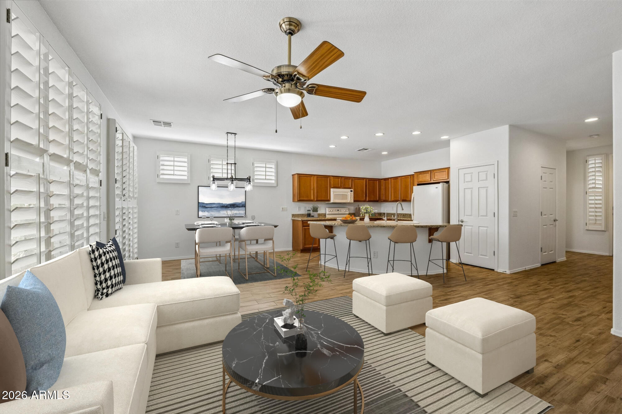 Welcome to Trilogy at Power Ranch, a premier 55+ community where lifestyle meets comfort! This popular Verbena floorplan offers tile flooring throughout, fresh interior paint, and plantation shutters for a bright, stylish feel. The open kitchen features granite countertops and pull-out cabinet shelving, plus a programmable Nest thermostat for efficiency. Enjoy Arizona living on the paver patio with pergola - perfect for relaxing or entertaining. Front and back security doors add peace of mind, while low-maintenance landscaping includes an irrigation timer system. Ideally located near shopping, dining, and medical services. Residents enjoy a clubhouse, fitness classes, tennis, pickleball, pool, spa, walking paths, and golf course.  Resort-style living every day!