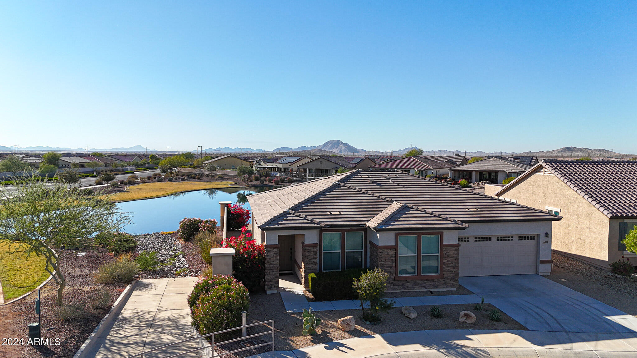 Beautifully upgraded home in Guard Gated Adult Community at  CantaMia. This Aria Model, Split Floor Plan with nice entry to Spacious Great Room overlooking Bright Kitchen with upgraded 42'' Cabinets, Island , Breakfast Bar, Granite Countertops, Backsplash, all Stainless Steel Appliances & Pantry. Master Bedroom with Bathroom /  Walk-in Shower, Double Sinks, Private Toilet area and walk-in Closet plus Two Guest Bedrooms and full Bathroom.  Dining Room with walk-out to a Covered Patio to relax with Amazing Views of the Lake and  surrounding Mountains with beautiful Sunsets. Enjoy all Amenities that CantaMia has to offer, including Pools, Fitness Facility, Game Rooms, Pickleball and much more.    **This could be your Dream Home**Mint Condition**Move-in ready**
