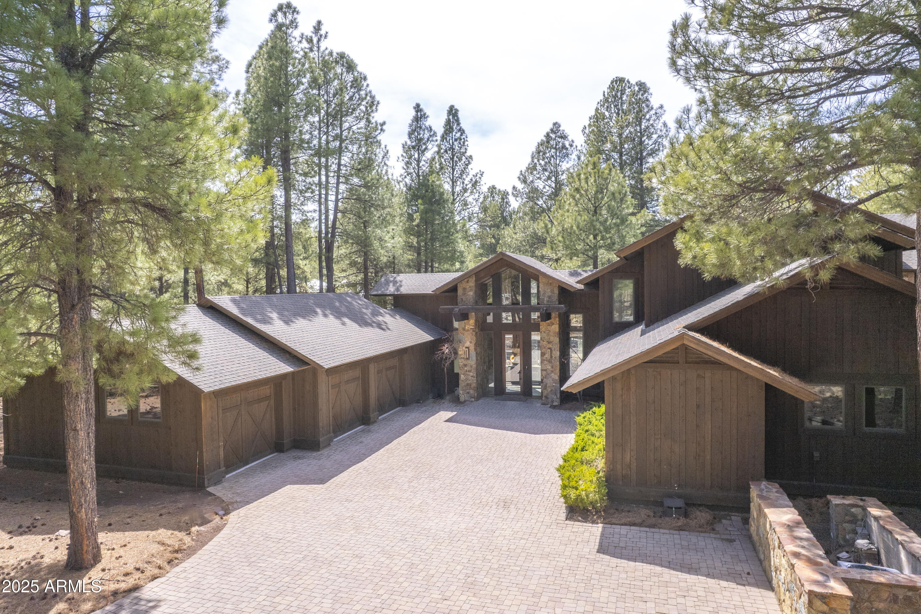 This mountain retreat is a modern masterpiece with the perfect blend of rough sawn barnwood exterior, natural stone, exposed timber trusses and beams, 18X18 sandlewood slate flooring and hammered steel railings and accents. The great room offers spectacular views of the 14th fairway and lake of the Meadow course and boasts a spectacular floor to ceiling stone fireplace, cathedral ceilings and open to the chef's kitchen.  There are 2 master suites on the main level as well as a 3rd guest bedroom (could also be a perfect office).  Upstairs are 2 more large bedrooms with ensuite baths, custom, built-in bunkbeds and a large loft area that is versatile to accommodate whatever your mind wants to create. The large Trex deck with firepit, sitting areas and dog run capture the beauty of the golf course, forest of trees and an off in the distance lake.  With both forced air and in-floor heat in certain areas, managing the comfort of this home is a breeze.  And of course, for the summer, central air conditioning.  Bring the cars and toys as the oversized 3 car garage has plenty of space for them all!