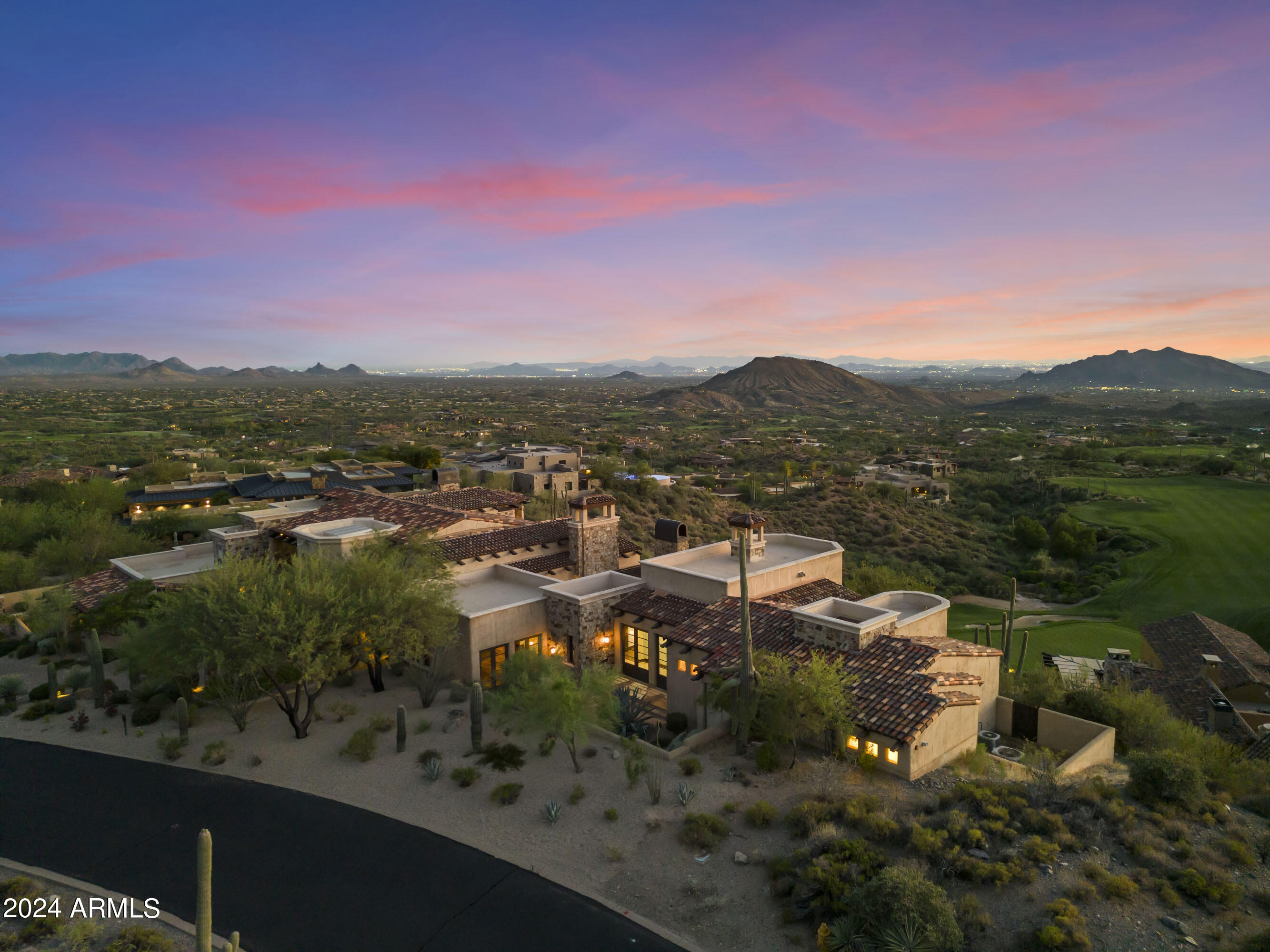 No reserve AUCTION, Bidding ends this Thursday 10/17 - Previously Listed $5.9M  Current High Bid $3.5M. The pinnacle of desert luxury awaits. Thoughtfully designed to blend into the beauty of the landscape that surrounds it, The Chiricahua Estate enjoys expansive views of the iconic Sonoran Desert, endless city lights, colorful sunsets, and sits above 18th green of the Chiricahua Golf Course. Abundant windows and French doors connect the common areas with the terrace for the ultimate indoor-outdoor lifestyle. The interior spaces flex from formal and distinctive to casual and inviting. Surrounded by gorgeous native plants and shade-giving trees, the estate's primary terrace begs to be shown off. Invite guests for a refreshing swim or hot tub soak... before sunset happy hour and a gourmet meal under the stars. At night, The Chiricahua Estate offers a truly spectacular view of the night sky and Scottsdale's glittering skyline. Enjoy a glass from the cellar by the fire, or relax in the serene primary suite with a balcony for two, a perfect spot to take in the clear desert air, bright blue skies, and the striking Saguaros below. Available Golf Membership.