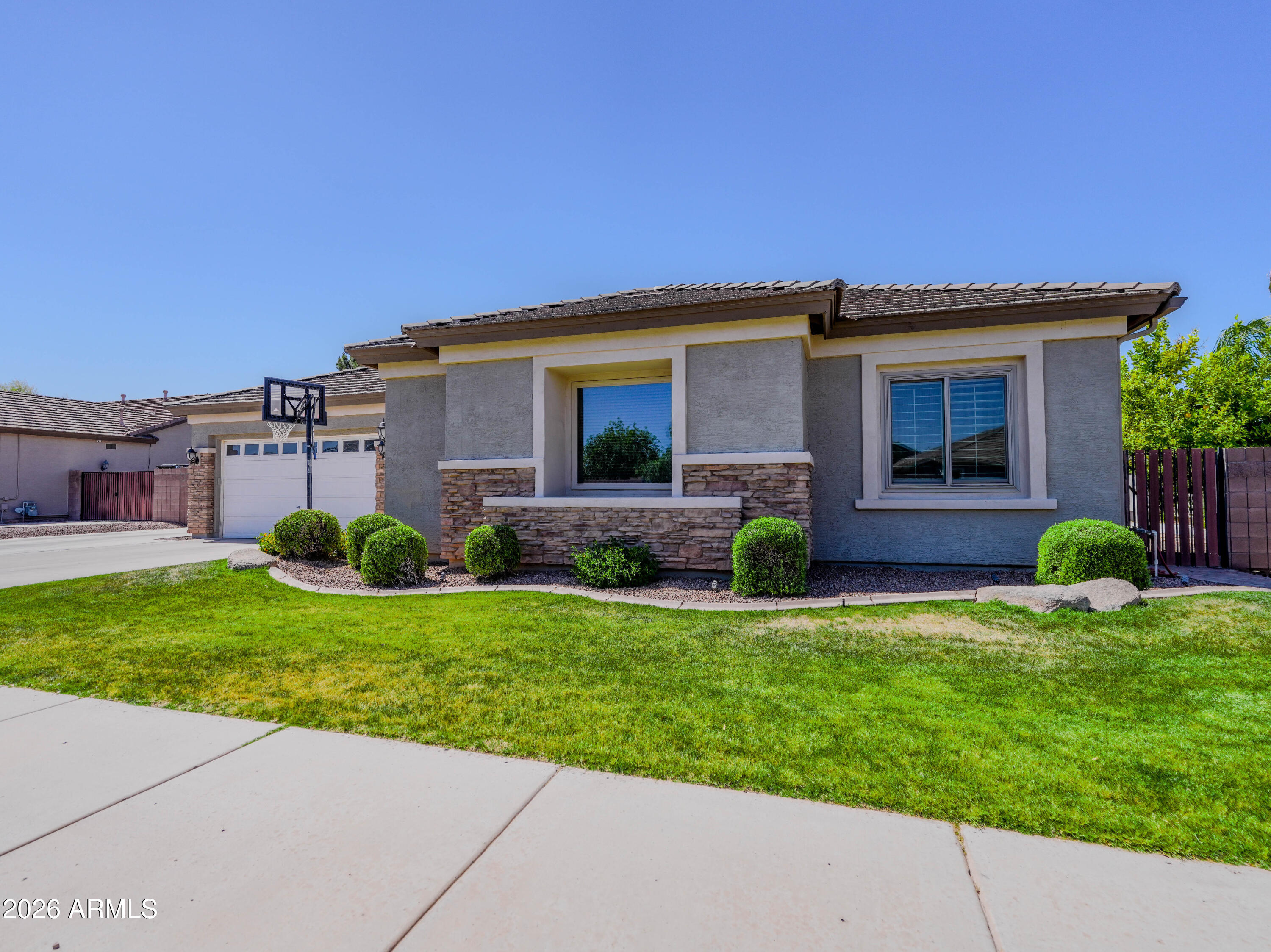 Beautiful executive basement home in the desirable Cortina community, offering luxury, comfort, and privacy. Prime location near top shopping & dining in Gilbert and Queen Creek. The gourmet kitchen features marble and granite counters, premium stainless appliances, custom cabinetry with plenty of storage, and a double oven. The expansive basement includes a 22x19 entertainment lounge, full wet bar, two guest rooms, & a beautifully finished full bath. This home has extensive upgrades. A resort-style backyard offers a PebbleTec pool & spa, extended travertine patios, outdoor fireplace, mature landscaping, and mountain views with no neighbors behind. Additional upgrades include custom paint, tall baseboards, surround-sound wiring, marble island, and solar panels for excellent energy saving.