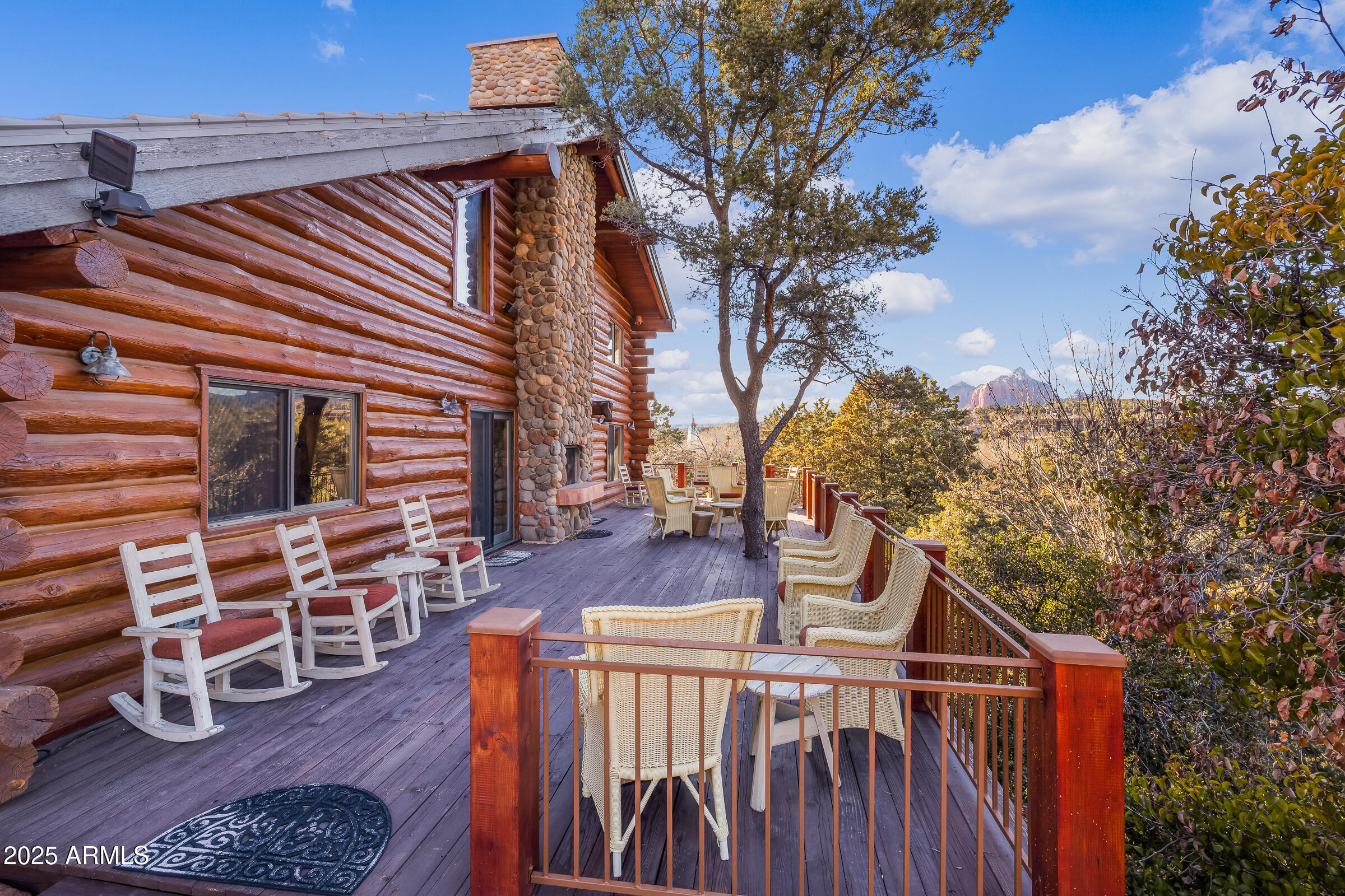 This charming log home features stunning 180-degree views of the famous Red Rocks and Uptown, and offers 2,261 square feet of living space, including an inviting 805 square foot guest house on over 3 ACRES in UPTOWN SEDONA! The main house boasts a spacious high ceiling and a cozy stone fireplace, while the guest house has its own fireplace and a covered porch with amazing views, PLUS Elvis Presley once stayed here while shooting a Western in the 1960's!ZONED RS-18 and so more units can be built which is very rare in Sedona. No HOA-would be an amazing Airbnb/VRBO/Short Term Rental. The Elvis Casita is self-contained & has washer/dryer & can be rented separately! With a large 2-car carport, this property is conveniently located just a few blocks from local amenities. The well-maintained guest house adds extra appeal, and its prime location provides great potential for expansion.

Connected to city sewer and natural gas, this private retreat is surrounded by beautiful trees. A visit will reveal its charm and wonderful possibilities.