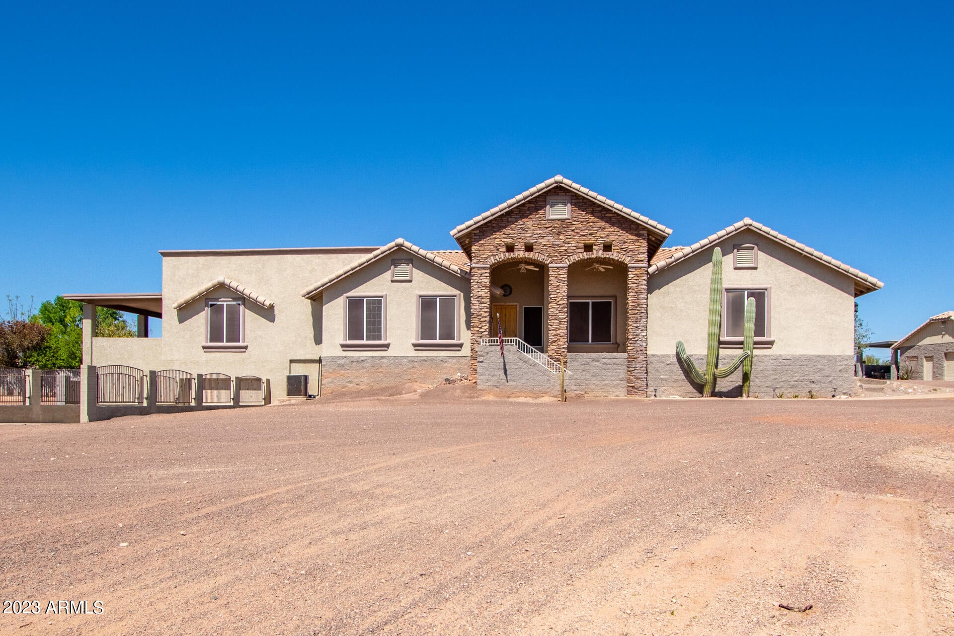 SELLER WILL CARRY!!!  2.4-ACRE LOT with ROOM FOR HORSES and MORE, 8 CAR GARAGE and RV PARKING. This beautiful 4-bed + bonus room, 3-bath home on a large 2.4-acre  is the one! Be greeted by a private street, charming desert landscape, stone accents, and a welcoming porch. Enter the enchanting interior high lighting designer tile and wood flooring, vaulted ceilings, recessed lighting, a bay window, and plantation shutters. Gather loved ones in the spacious great room with a free-standing fireplace. The eat-in kitchen boasts granite counters and backsplash, pendant lighting, paneled cabinets, a walk-in pantry, sparkling SS appliances, a center island, and a peninsula with a breakfast bar. The large owner's suite includes a private bathroom with daul sinks and walk in closet. Create lasting memories in the bonus room w/ French doors leading to the balcony. You'll also find a basement for extra living space. Enjoy majestic mountain views on the balcony or the vast backyard offering a covered patio, an outdoor kitchen & fireplace w/ sitting areas, a refreshing pool, a storage shed, and basketball court.

Along with the huge lot and 2 garages there is a large 875 sqft shop/ garage that can be used for storage or a side hustle. With all the garages, 8 cars can be stored and there's even a RV carport to handle it all.