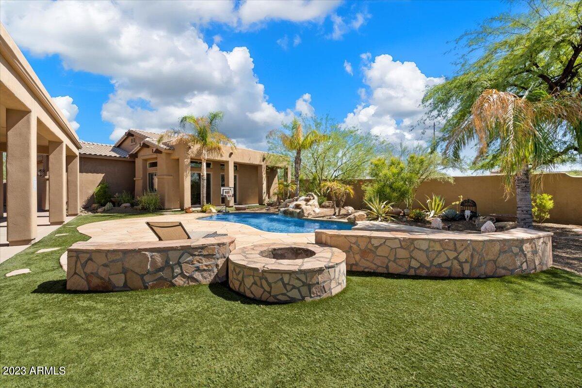 Situated on 1.25 acres in Cave Creek, the property has a Main House 4bed/3bath, 3,138sqft, and 3 car garage.  The Guest House is 2bed/2bath, 1,196sqft, separate gated driveway, RV garage with direct guest house entry. The Main House features a formal dining area, game room, soaring ceilings and gas fireplace. 3 car garage with built in cabinets. Entertainers kitchen with paneled oak cabinets, double ovens, stainless steel appliances, gas range, walk-in pantry. Sliding glass doors to the resort backyard - Covered patio, built in BBQ, outdoor shower, heated pool & spa. Nearby shops, restaurants, and amenities. Access hiking and biking trails from your doorstep. No HOA!