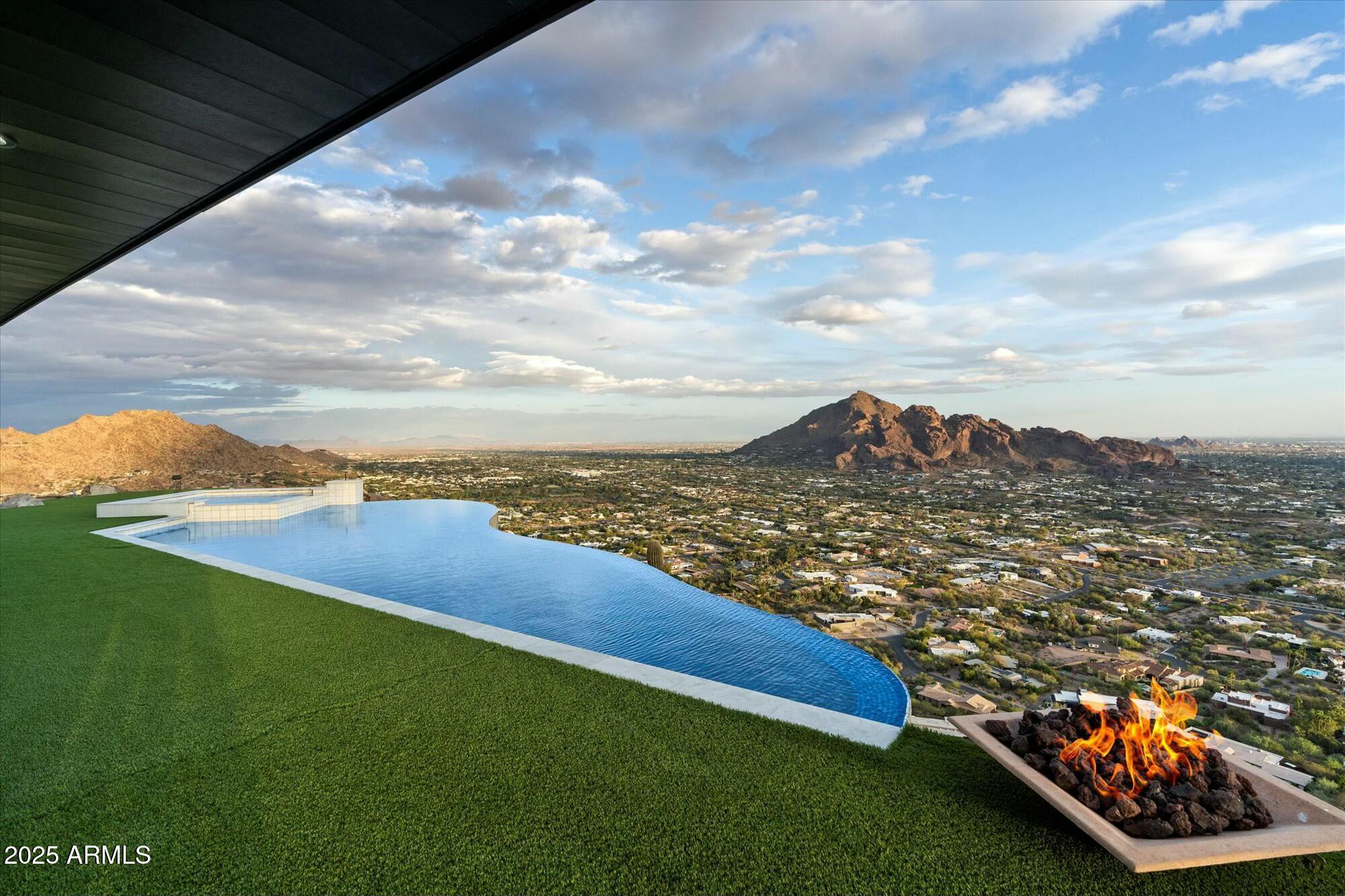 Ever dreamed of owning your own Mountain? This once in a lifetime opportunity to own your own 8 acre, single level, 5,000 sqft mountain top retreat is now. Spanning 4 separate parcels in an exclusive gated community of only 5 homes with no HOA. This stately, 360 degree view property provides the ultimate view experience, eye level with Camelback Mountain, higher than Mummy Mountain and the Phoenix mountain preserve, higher then downtown phoenix skyscrapers; vistas include Paradise Valley Country Club and Golf Course, the Biltmore Golf Course, and spectacular City Lights.  This gated estate is only minutes from Scottsdale Fashion square, World Class - Dining, Resorts, Golf, Night Life, Arts, Shopping, and Airports both Public & Private.  Live on top of the world in this trophy property.
