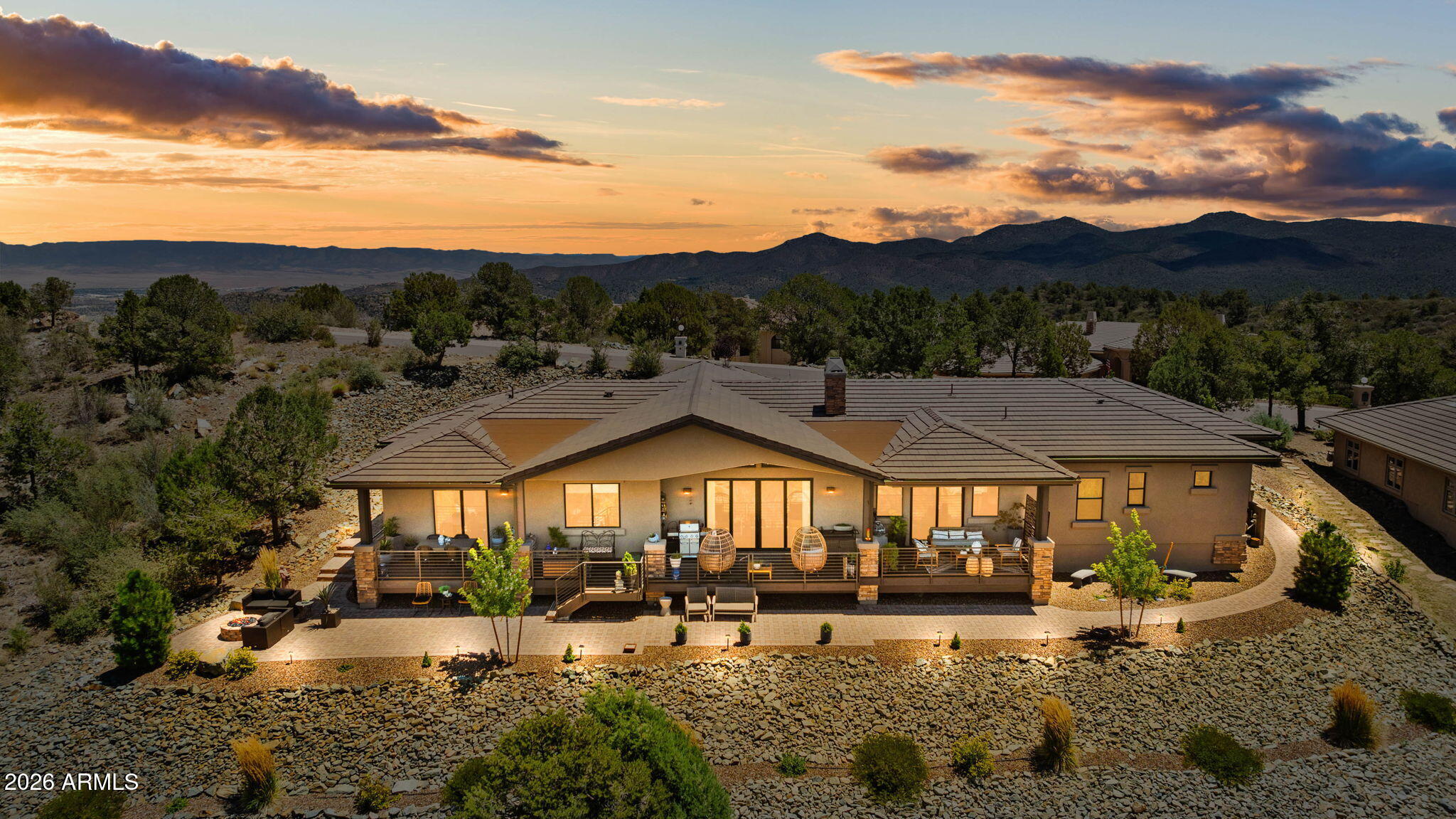 Discover this masterfully upgraded, lightly lived-in gem where sophisticated style meets mountain comfort. This stunning residence offers true single-level living with no-step entry, framed by some of the most exceptional views in the area. The heart of the home is a Great Room anchored by a floor-to-ceiling stone fireplace and upgraded designer lighting. A chef's dream kitchen awaits, featuring rich cabinetry, premium granite, a custom barn-door pantry, and top-tier Wolf appliances. The thoughtful split floor plan ensures privacy, headlined by a primary suite with fully insulated walls and instant hot water. Guests will love the junior suite, which offers direct access to the expansive covered deck. Outside, the living space excels with a cozy firepit, large deck area, & endless views.